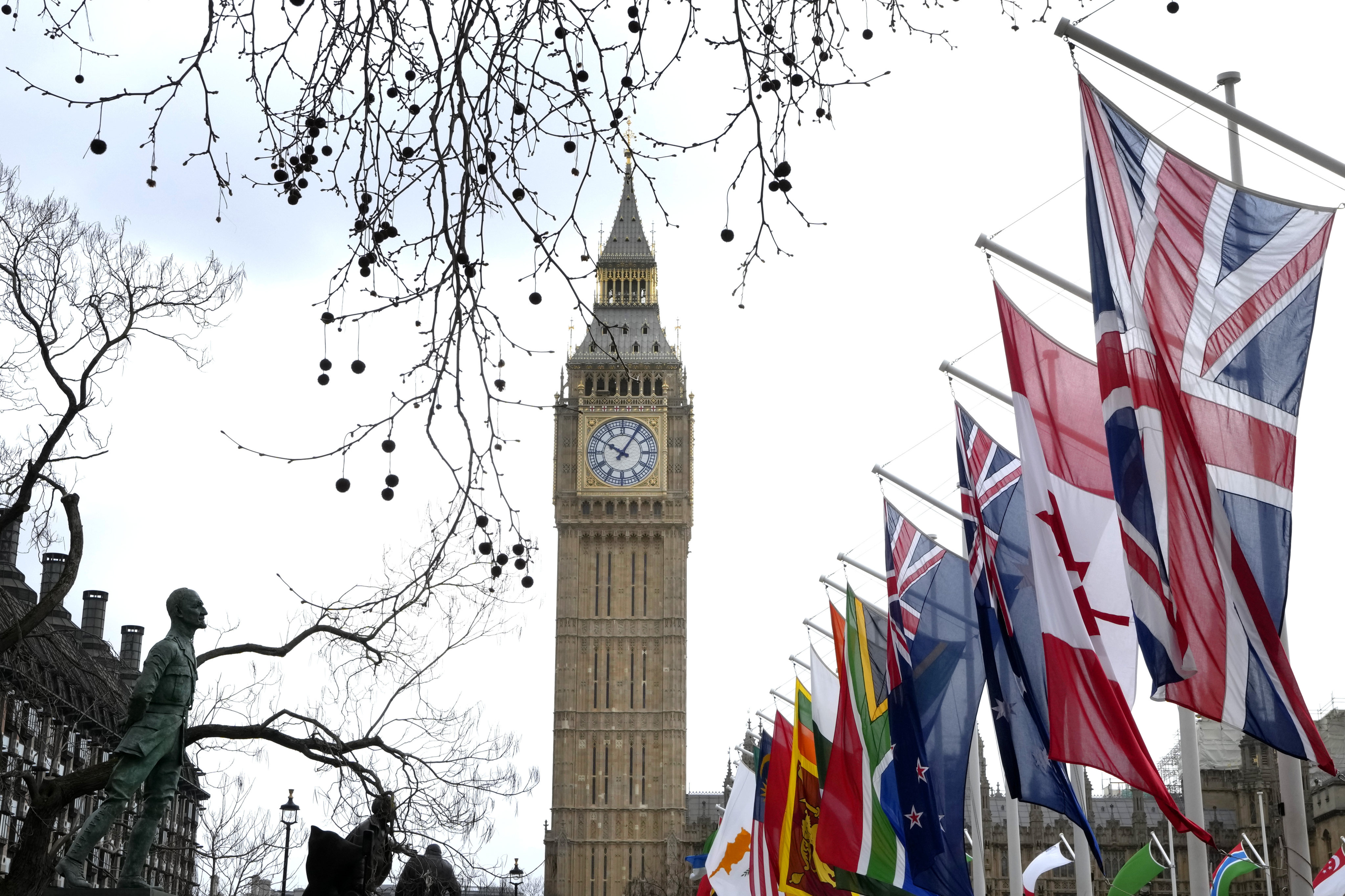 Flags of the Commonwealth countries fly near the Elizabeth Tower, known as “Big Ben”, in Parliament Square in London on March 13. Photo: AP