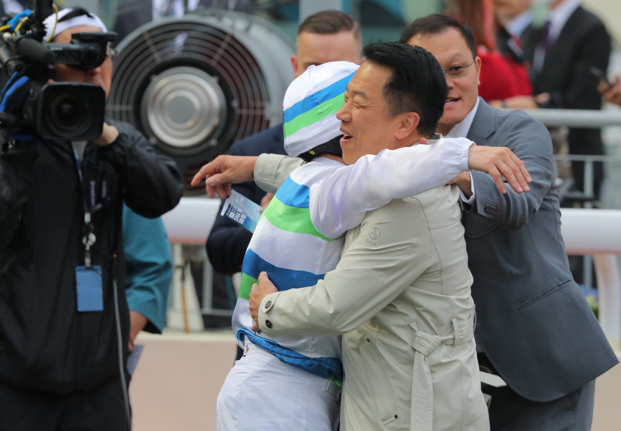 Jockey Alexis Badel and trainer Ricky Yiu embrace after winning the Hong Kong Derby with Voyage Bubble.