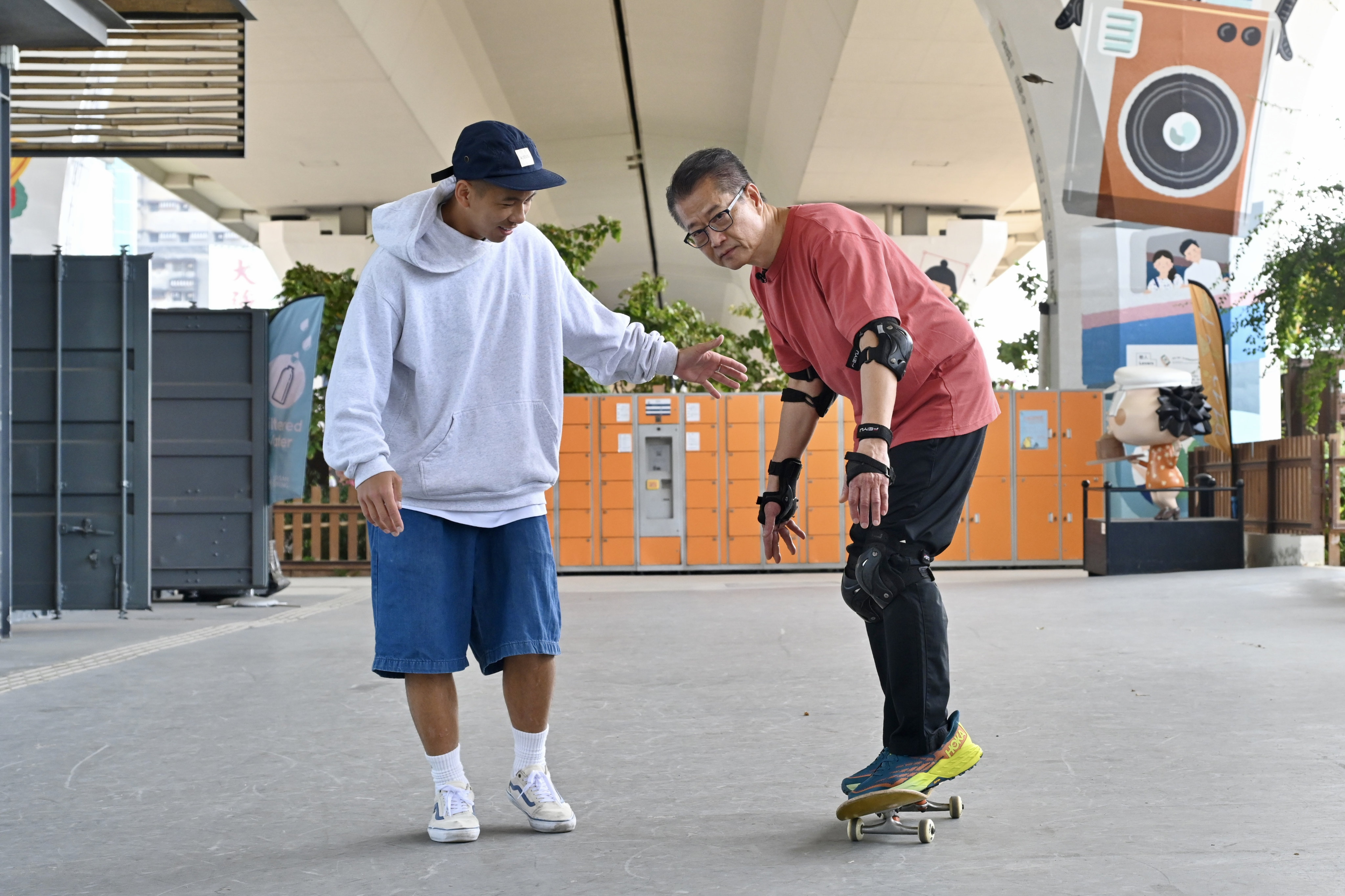 Financial Secretary Paul Chan (right) during last week’s skateboarding session with professional athlete Luk Chun-yin. Photo: Handout