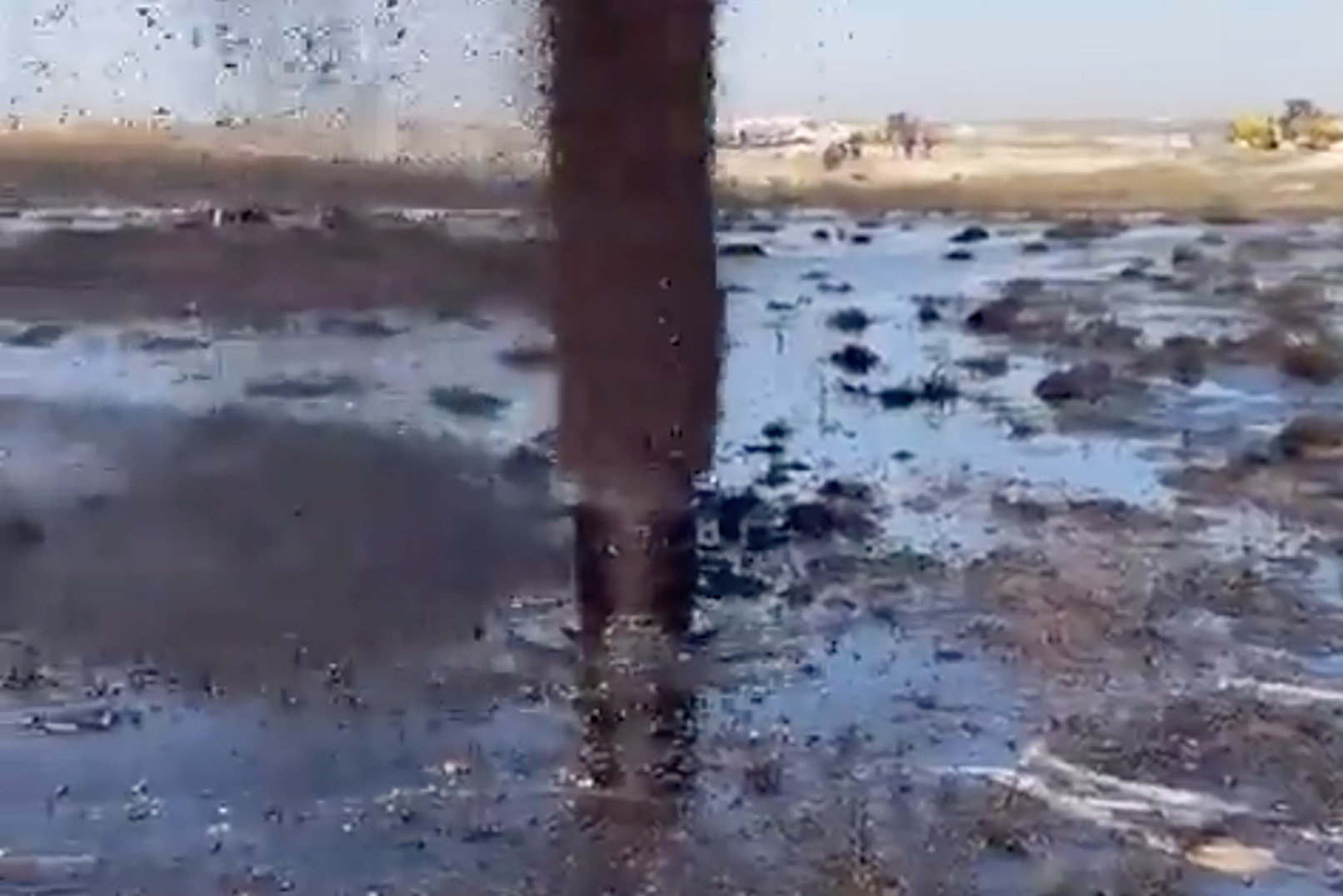 Screenshot from a video posted by Kuwaiti media shows a gushing pipe surrounded by a large slick of oil. The Kuwait Oil Company has declared a state of emergency. Photo: Twitter @AlraiMediaGroup