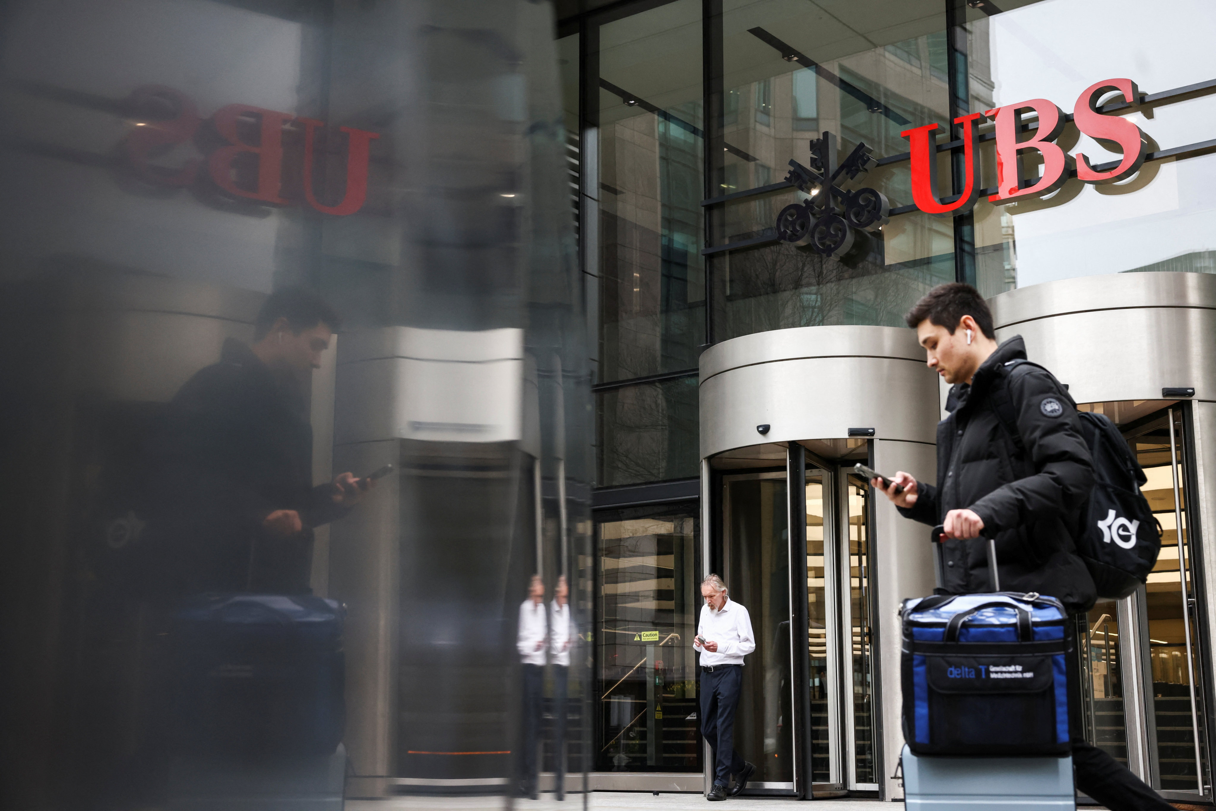 A person walks past the entrance of the UBS’s offices in London on  March 20, 2023. Photo: Reuters 