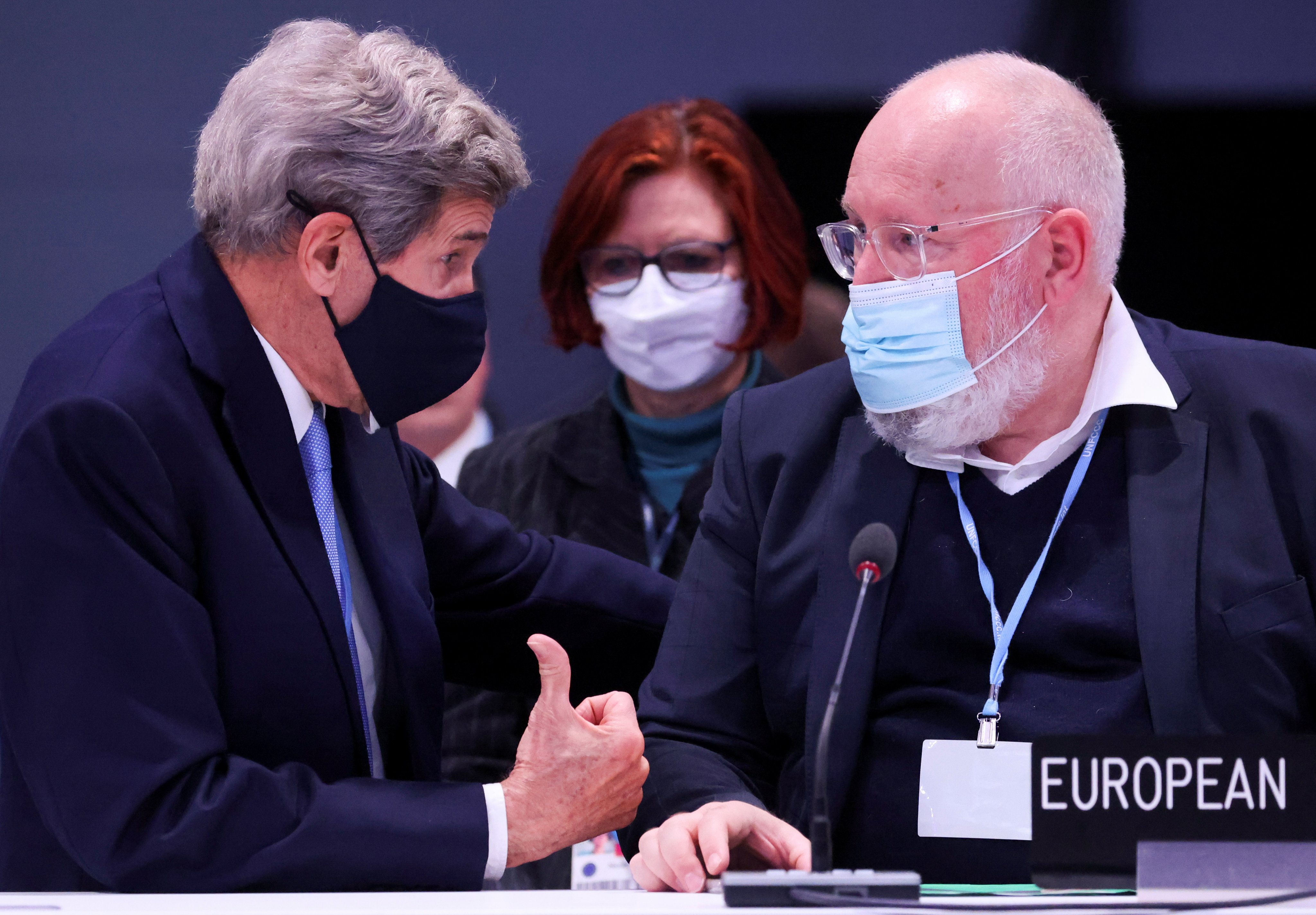 US climate envoy John Kerry speaks to EU climate czar Frans Timmermans at the COP26 UN climate change conference in Glasgow, Scotland, on November 12, 2021. Photo: Reuters