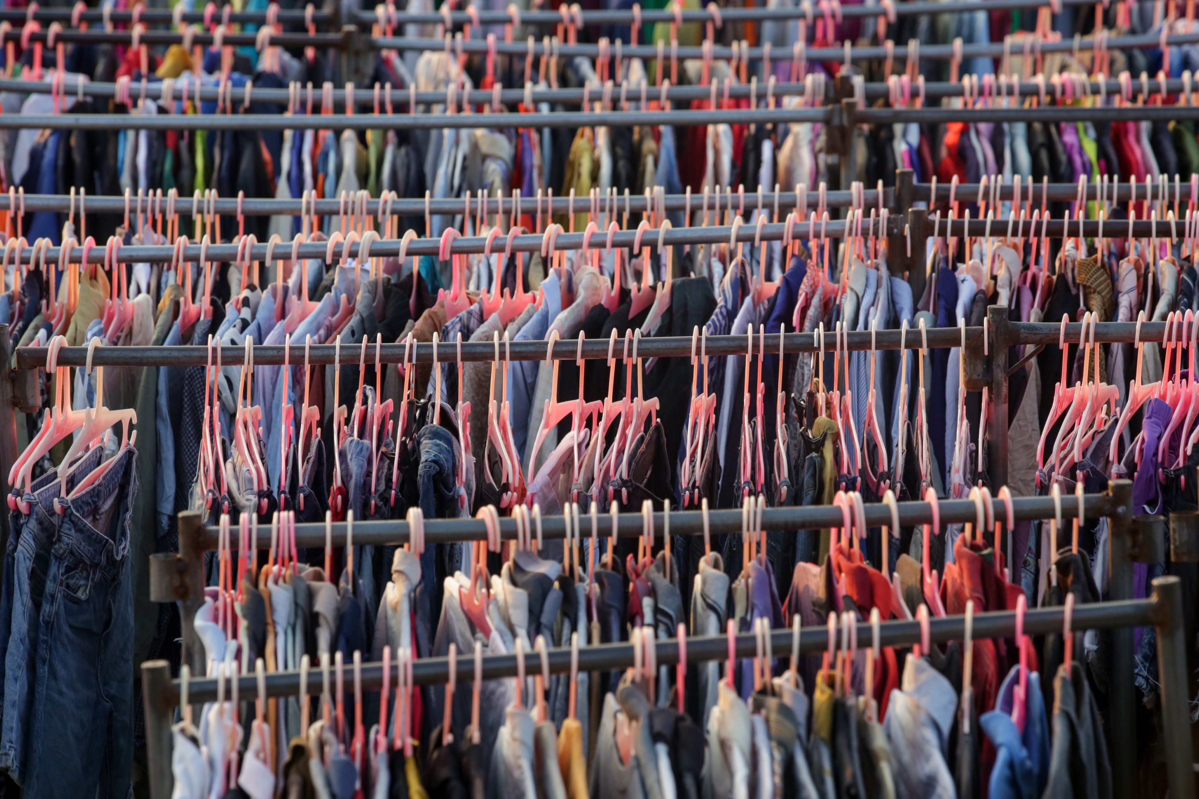 Used clothes on racks in a secondhand shop. For the last 70 years, we have measured the prosperity of countries using gross domestic product – how much the total sales of goods and services has grown, without acknowledging the social or climate impact from economic activities. Photo: Shutterstock