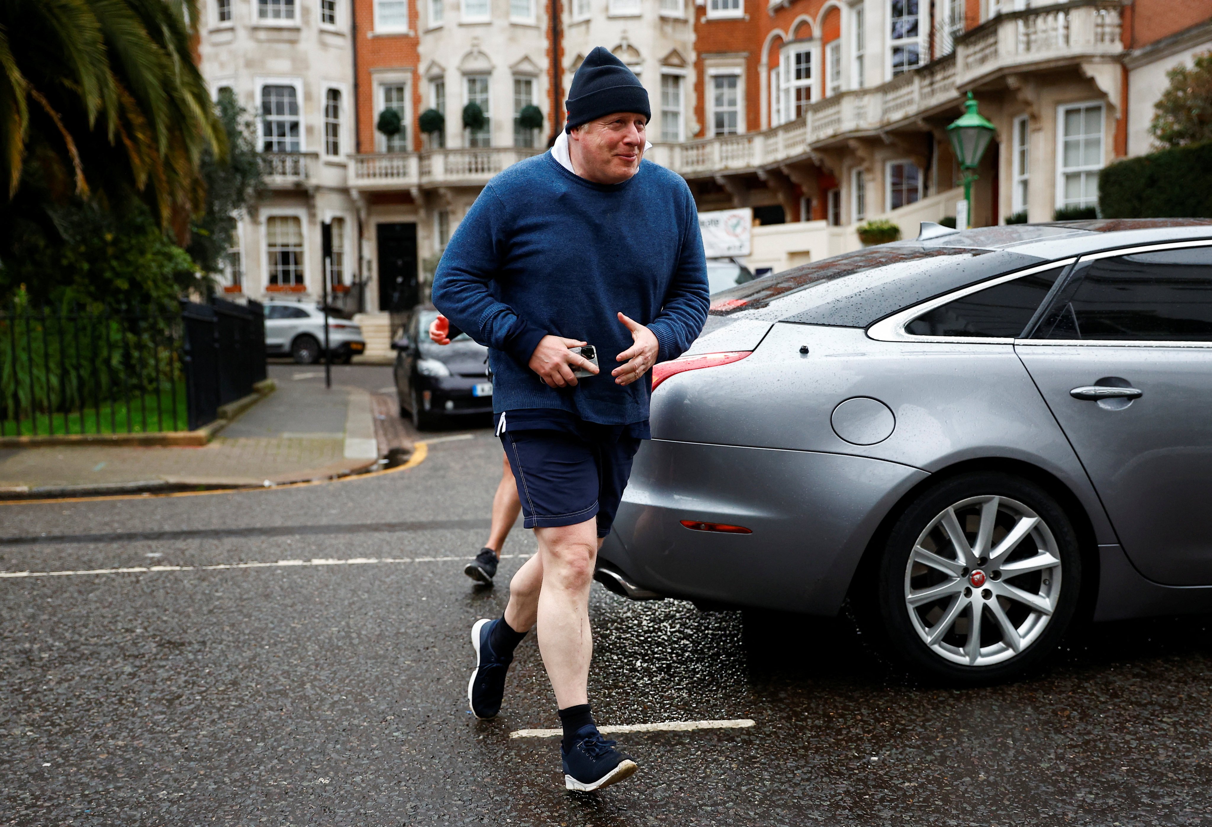 Former British prime minister Boris Johnson walks home after his morning run, in London, on March 21. Photo: Reuters