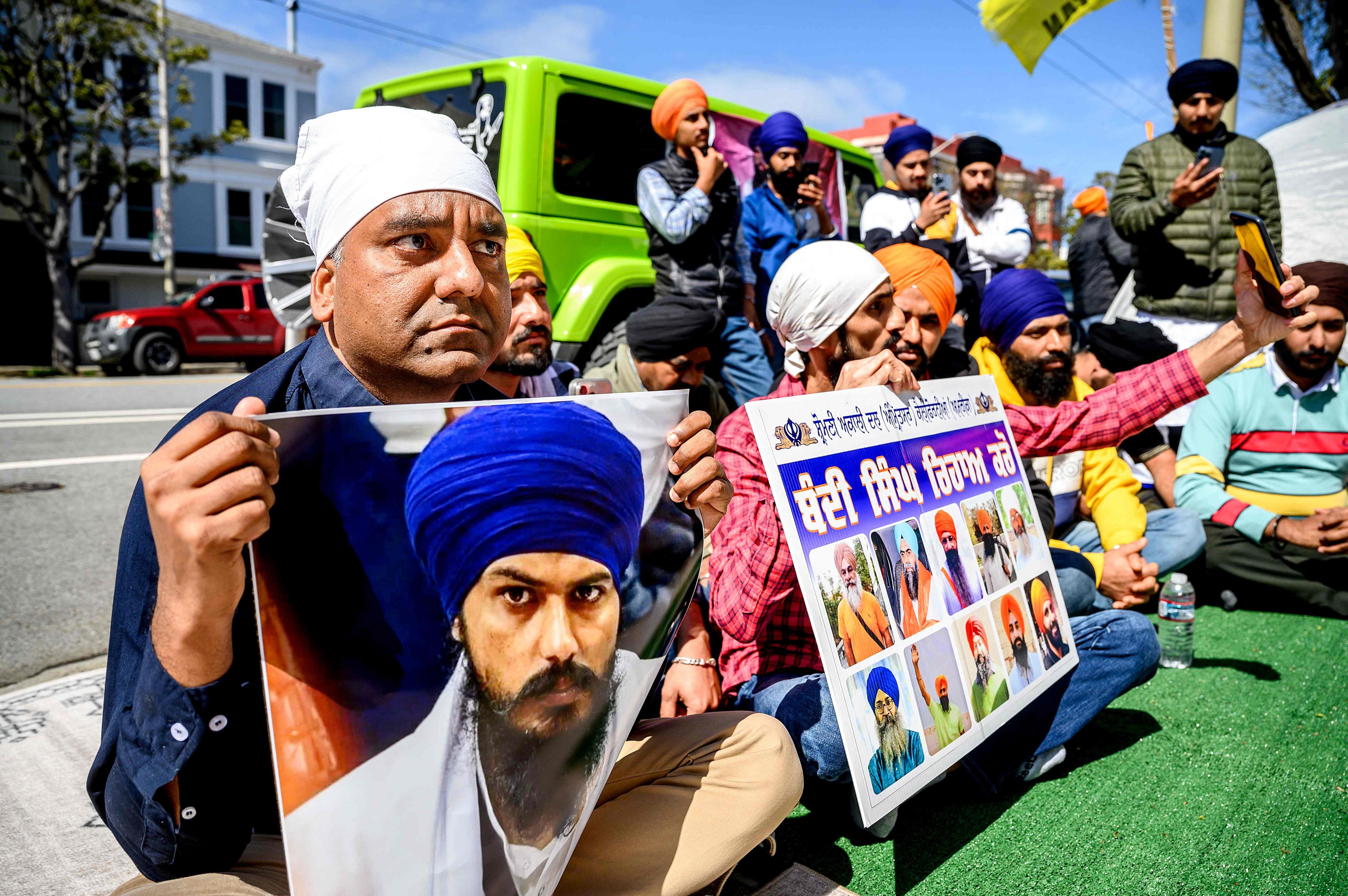Demonstrators hold a photo of Sikh organiser Amritpal Singh while protesting against the Indian government outside the Indian consulate in San Francisco on March 20, 2023. Photo: AFP