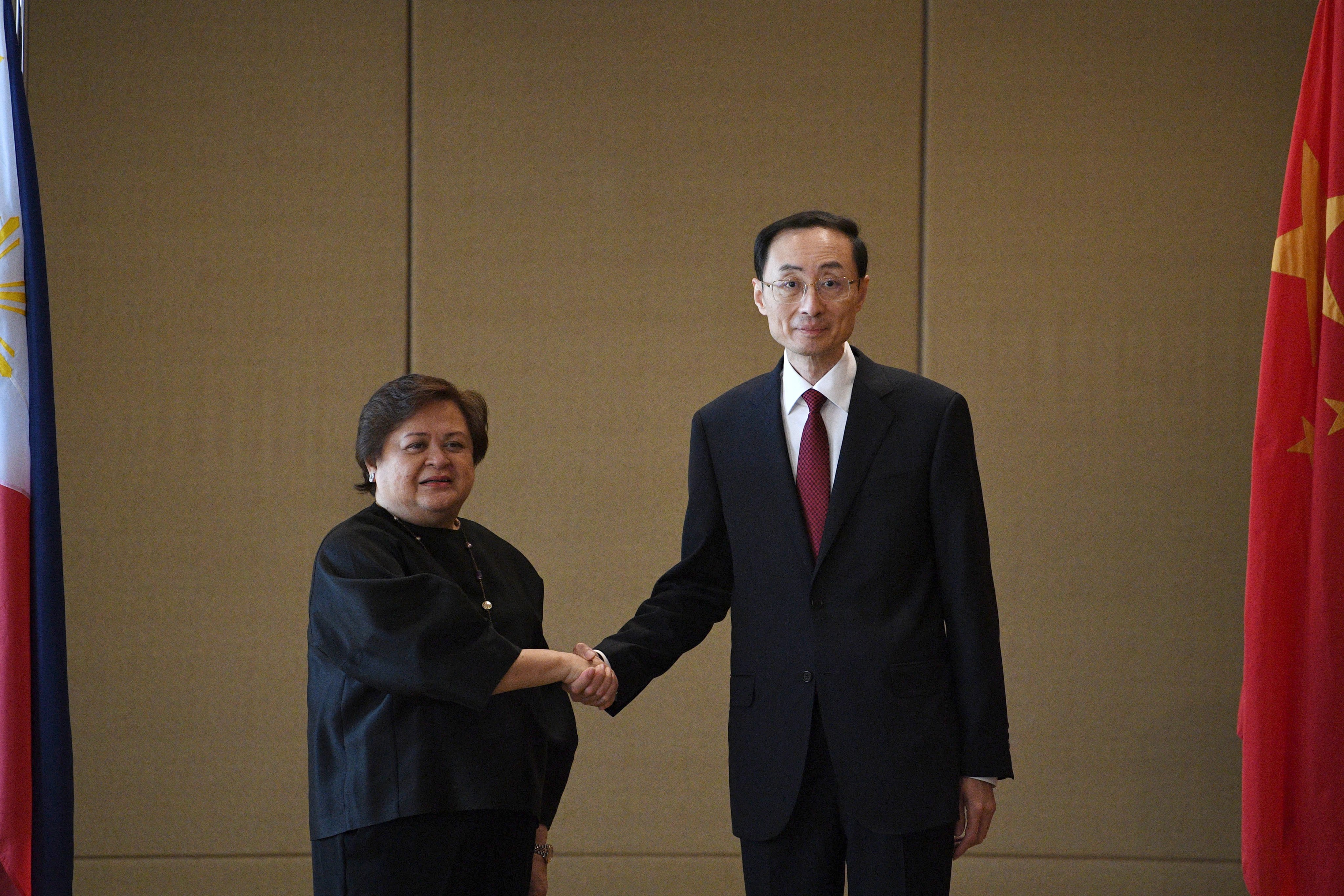 Filipino Foreign Affairs Undersecretary Maria Lourdes Lazaro and Chinese Vice Foreign Minister Sun Weidong shake hands during a bilateral meeting in Manila. Photo: EPA-EFE