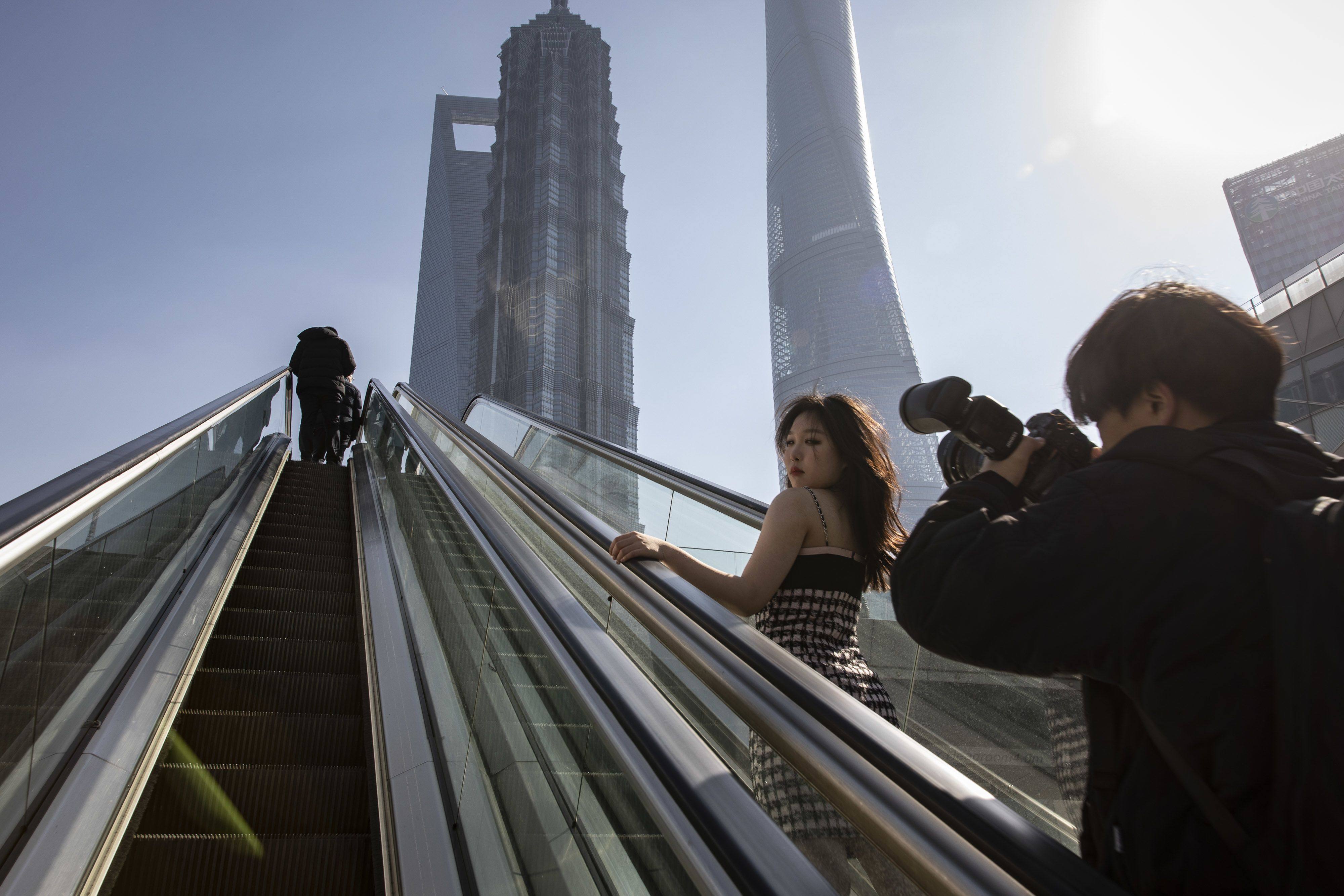 A woman poses for photos in Pudong’s Lujiazui Financial District in Shanghai on January 30, 2023. Photo: Bloomberg