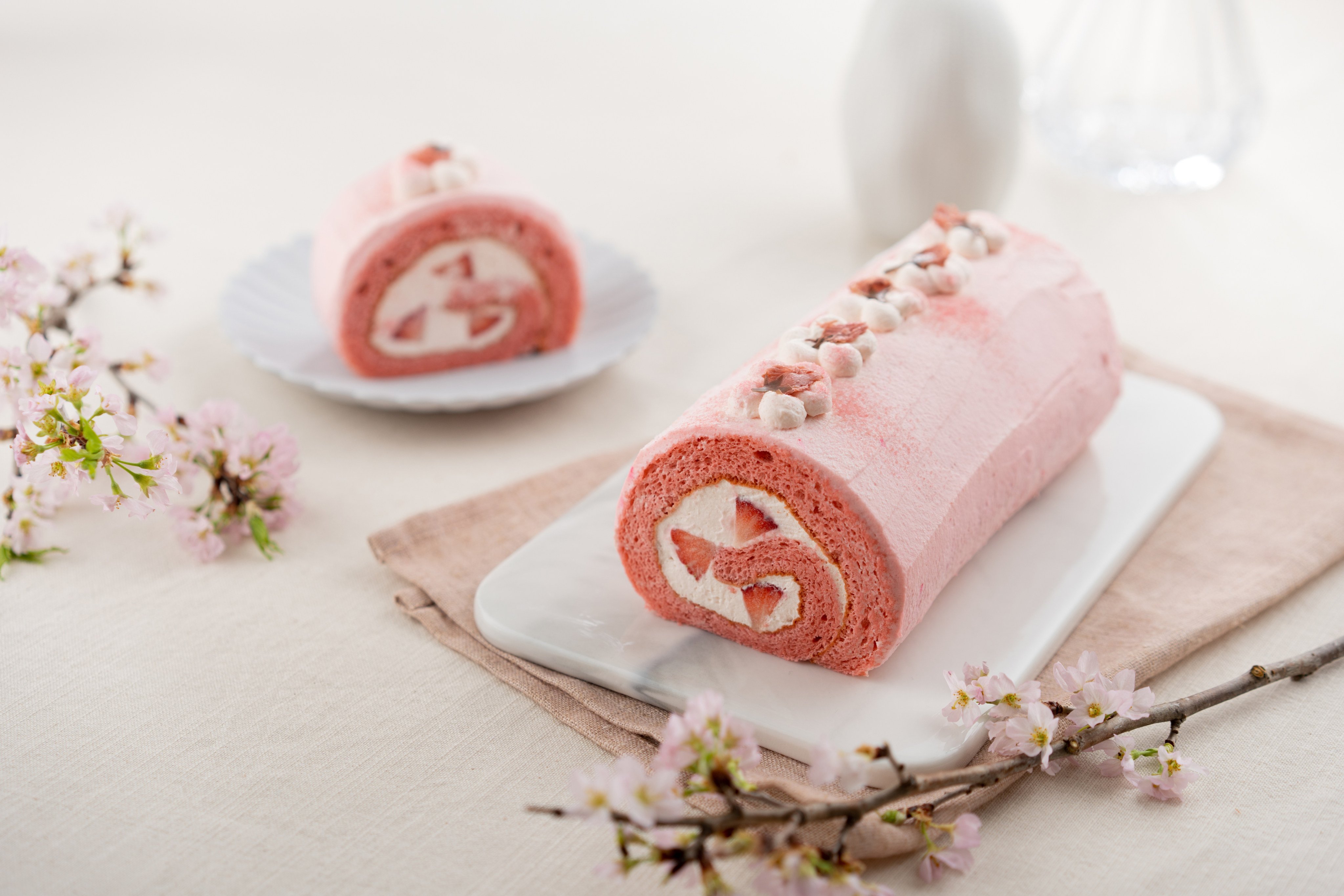 Sakura roll cake at Hong Kong patisserie Kiyoka, which infuses the Japanese cherry blossom throughout the cake dough, cream filling and with garnishes. Photo: Kiyoka
