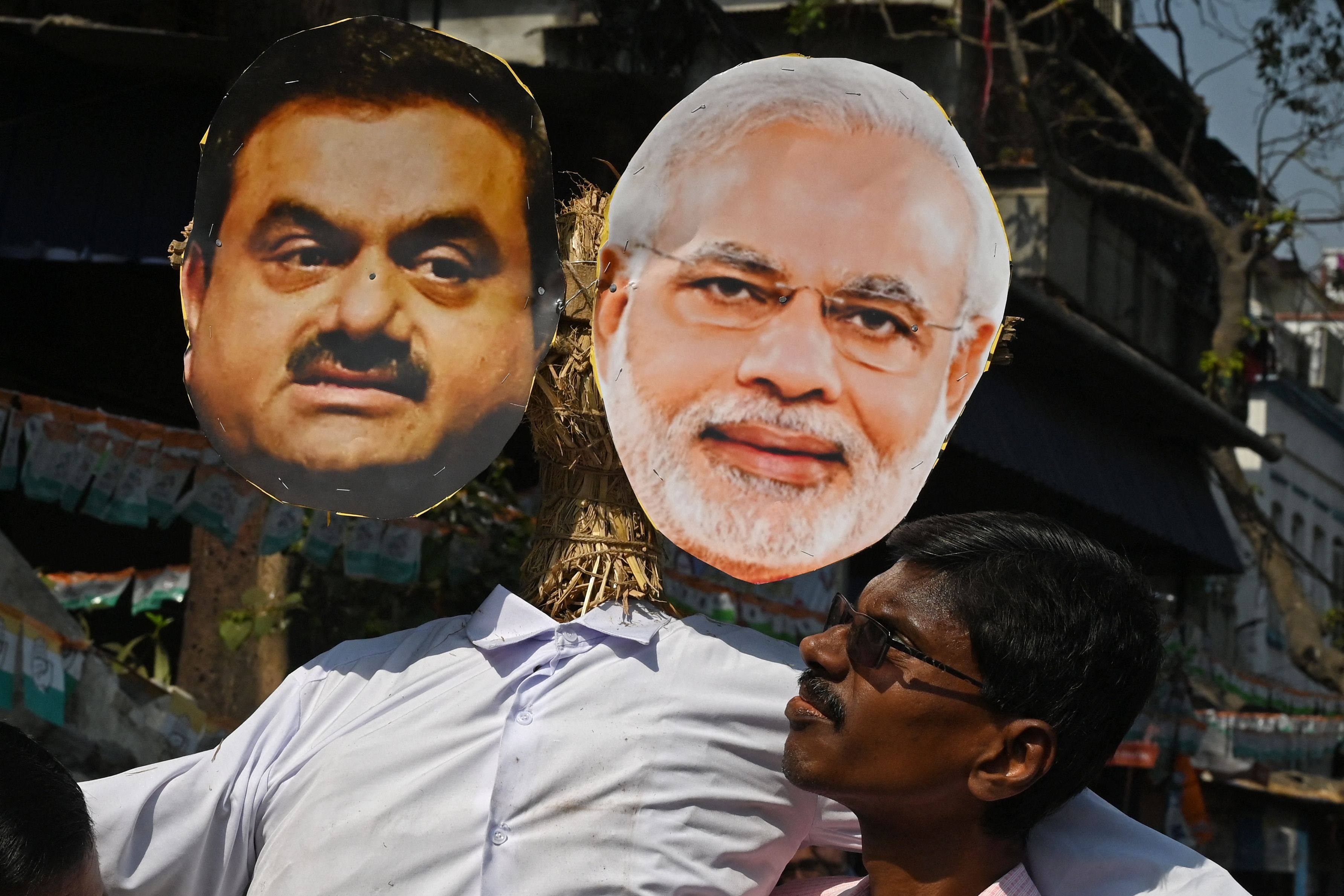 An activist of India’s Congress party carries an effigy of Prime Minister Narendra Modi and Indian tycoon Gautam Adani during a rally organised to protest against the union government’s financial policies. Photo: AFP/File