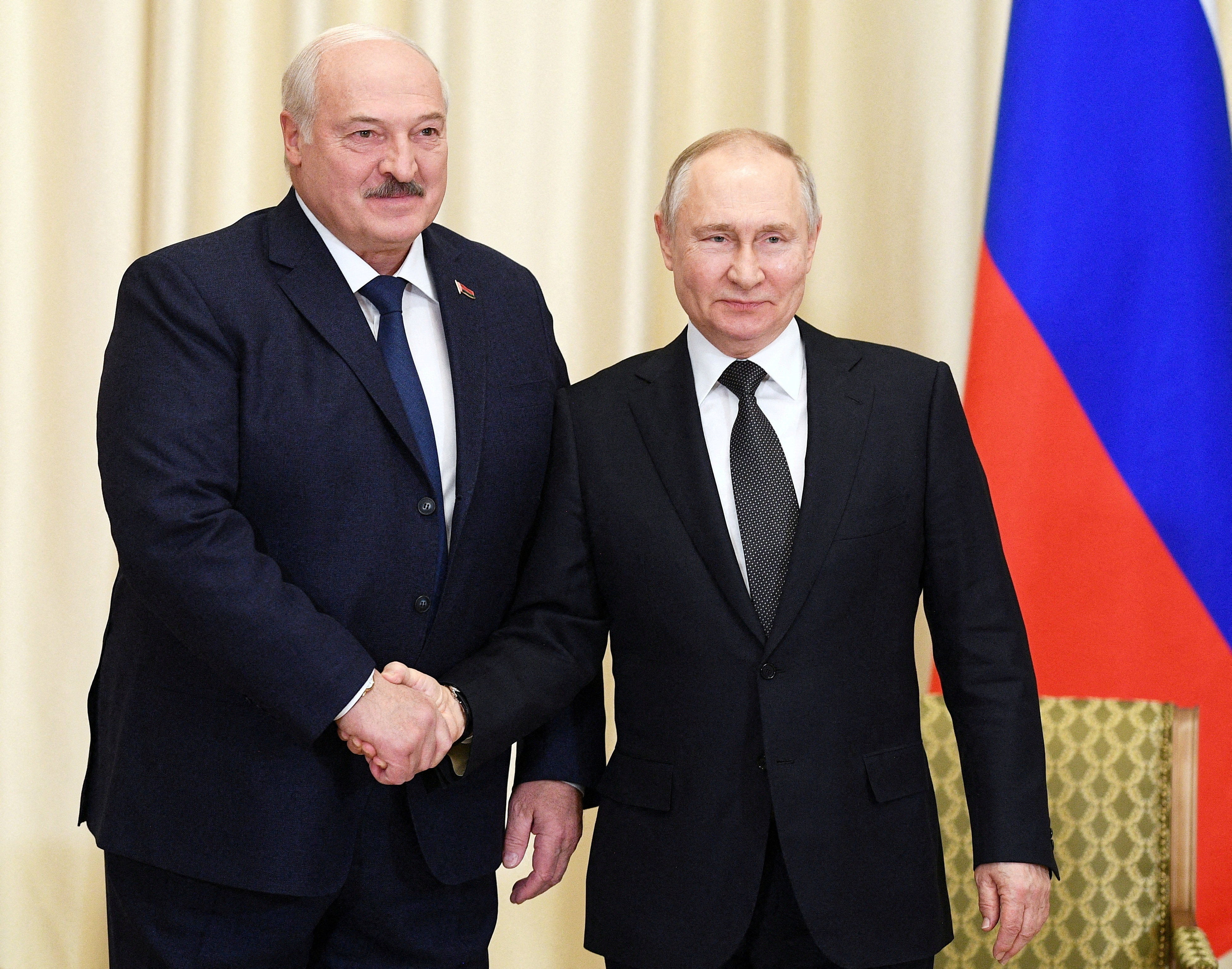 Russian President Vladimir Putin, right, shakes hands with Belarusian President Alexander Lukashenko near Moscow, Russia on February 17. Photo: Sputnik / Vladimir Astapkovich / Kremlin via Reuters