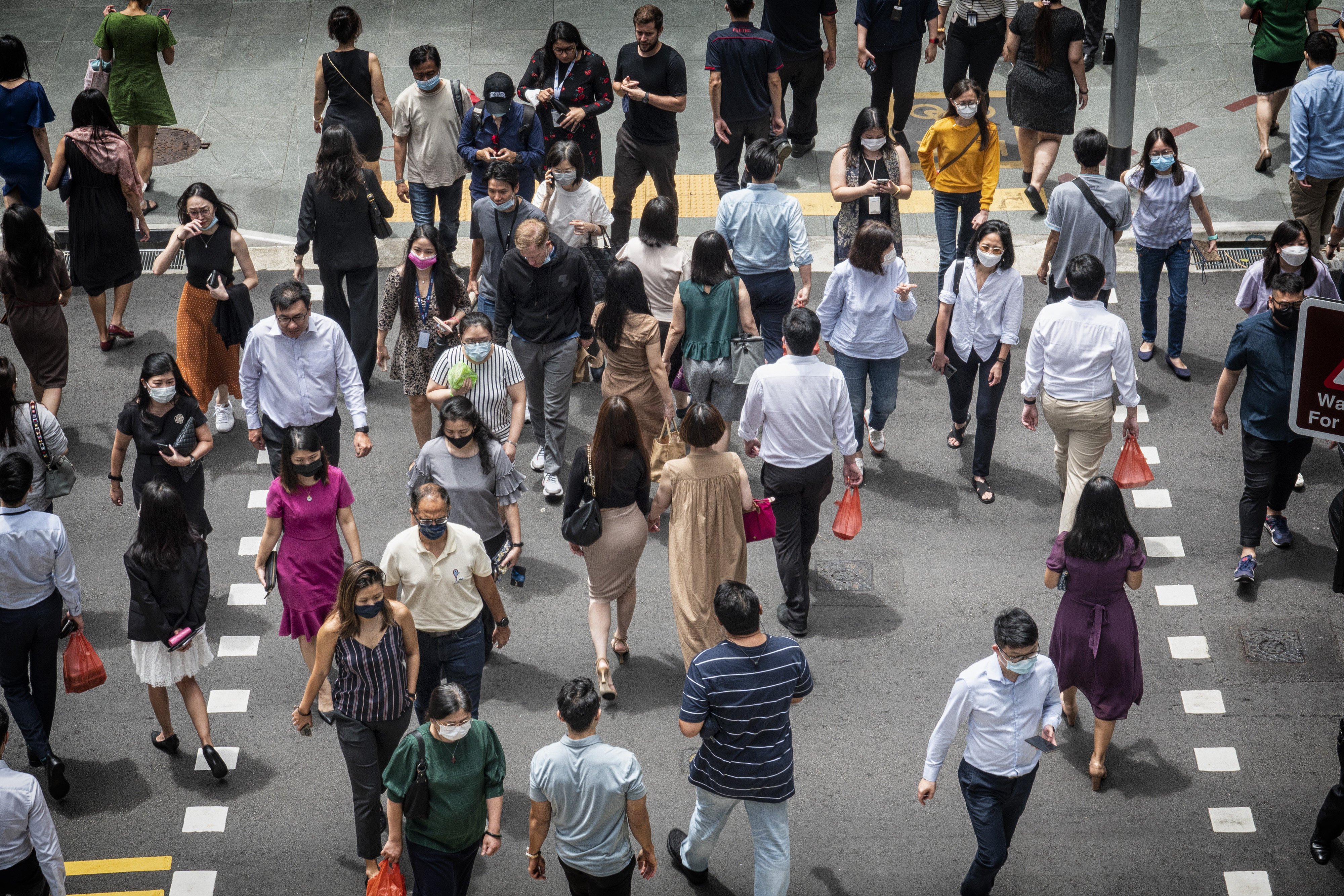 Pedestrians walk through Singapore’s central business district. Photo: Bloomberg