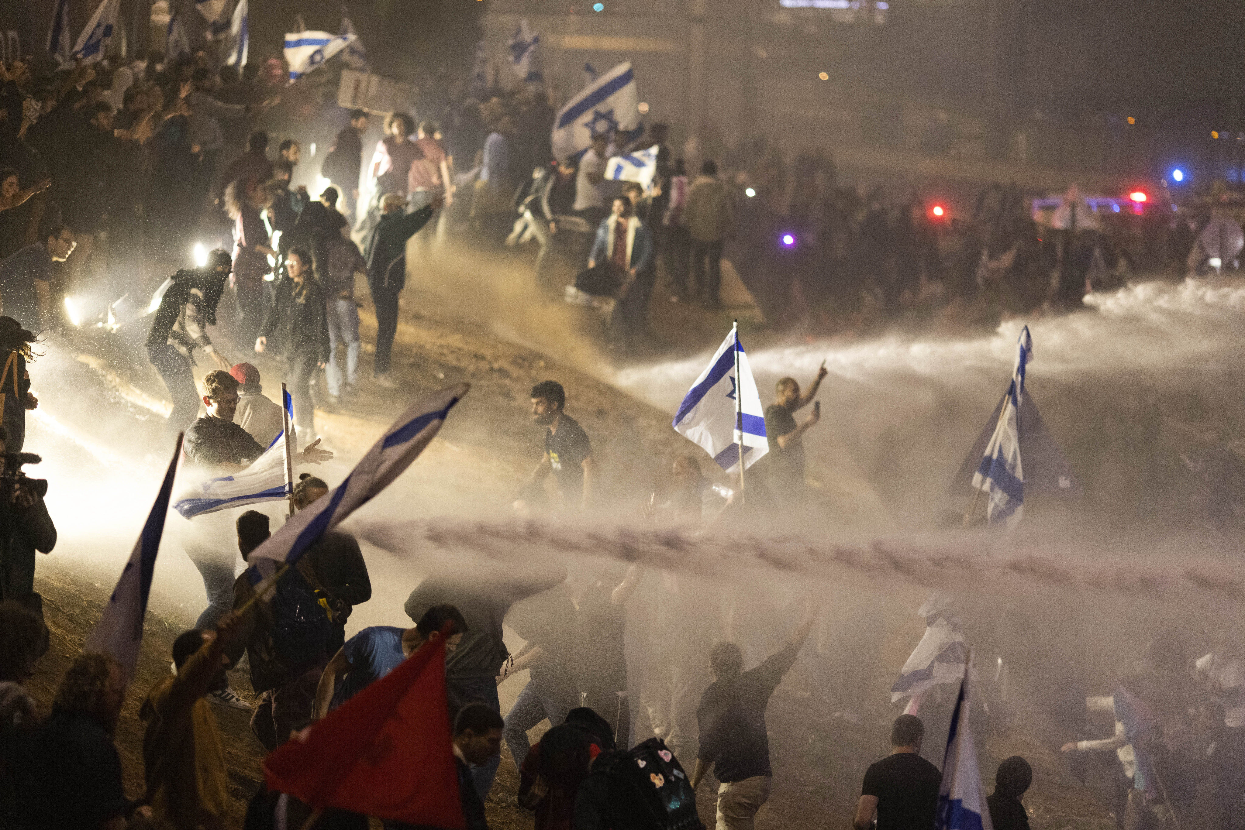 Israeli police use a water cannon on Monday to disperse demonstrators blocking a highway during a protest against plans by Prime Minister Benjamin Netanyahu’s government to overhaul the judicial system in Tel Aviv. Photo: AP