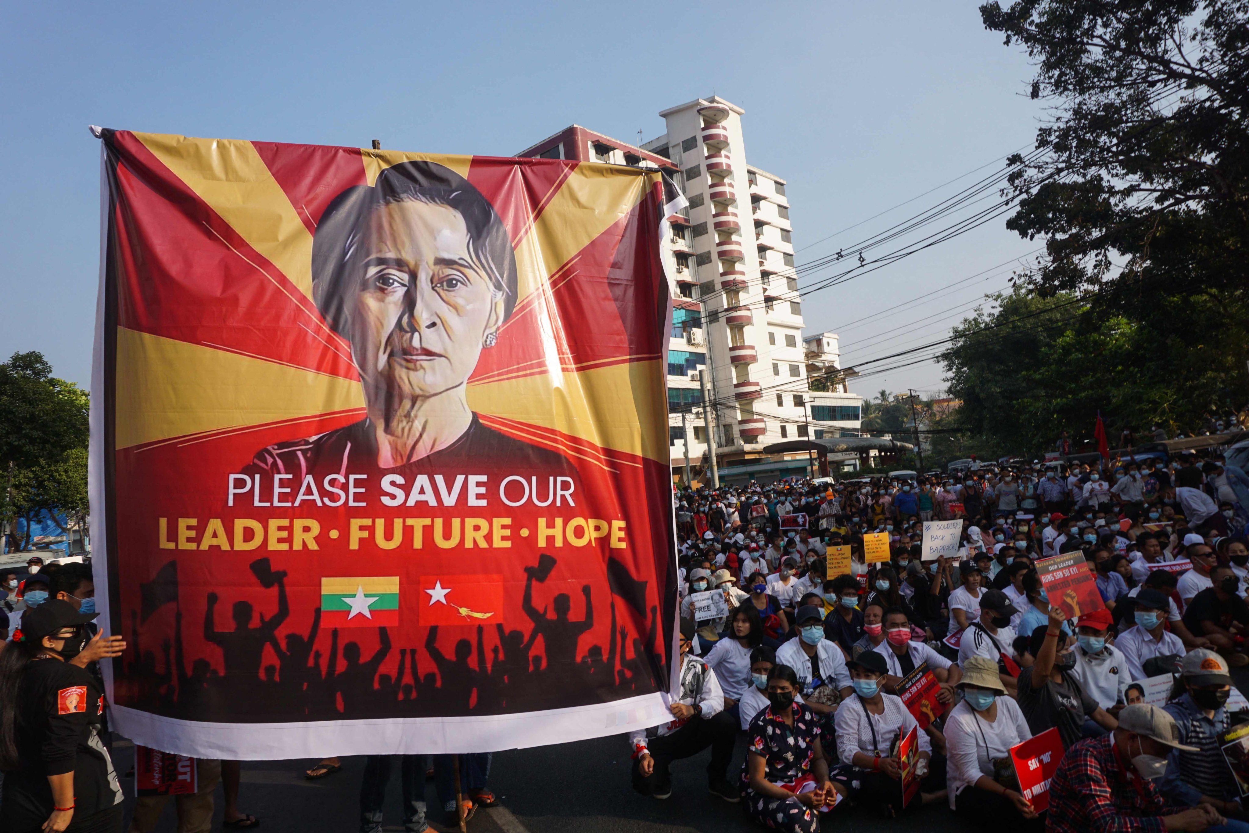 A banner featuring Aung San Suu Kyi is seen in February 2021 as protesters take part in a demonstration in Yangon against that month’s military coup. Photo: AFP