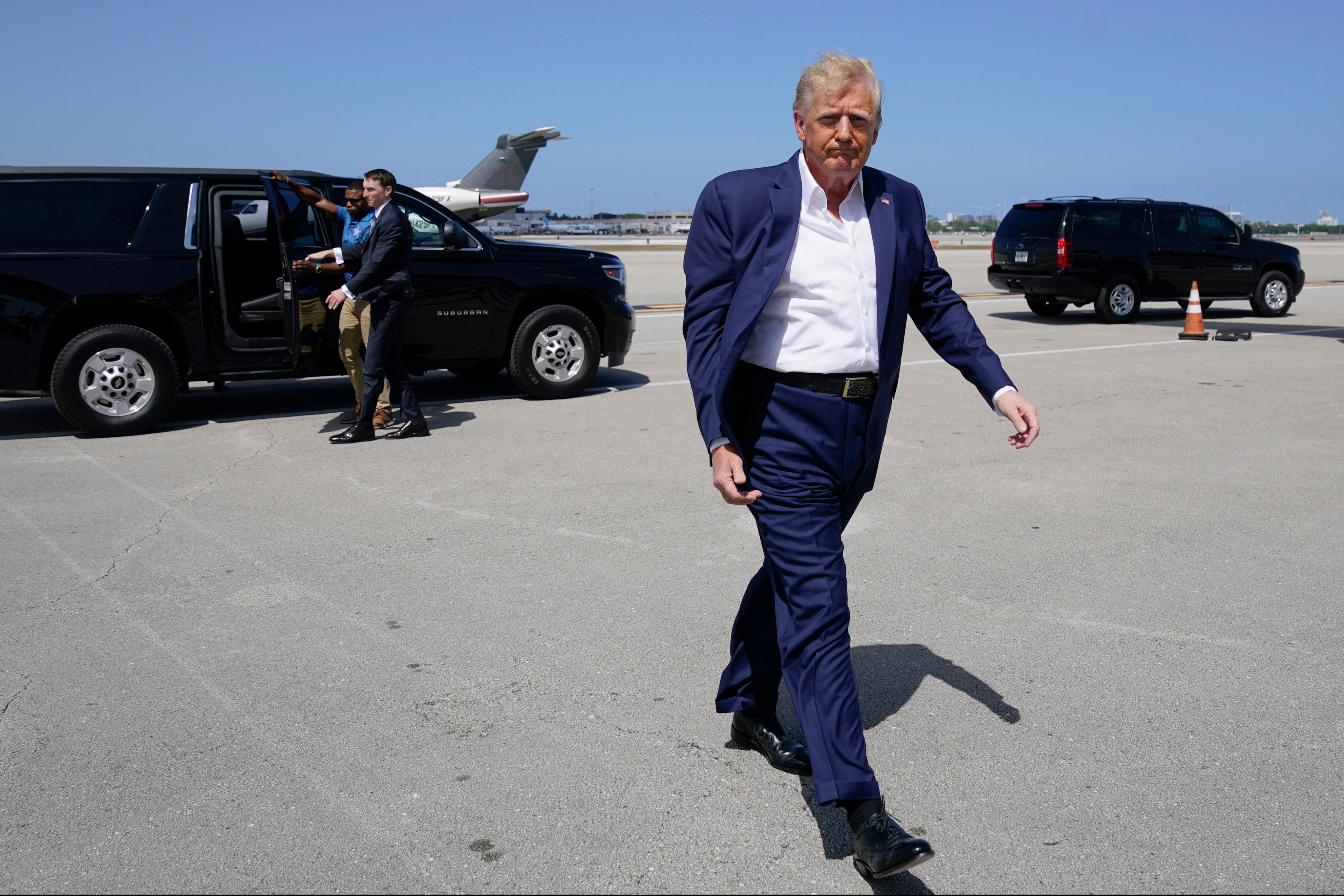 Donald Trump walks to board his airplane for a trip to a campaign rally in Waco, Texas, at West Palm Beach International Airport on March 25 in Florida. Photo: AP