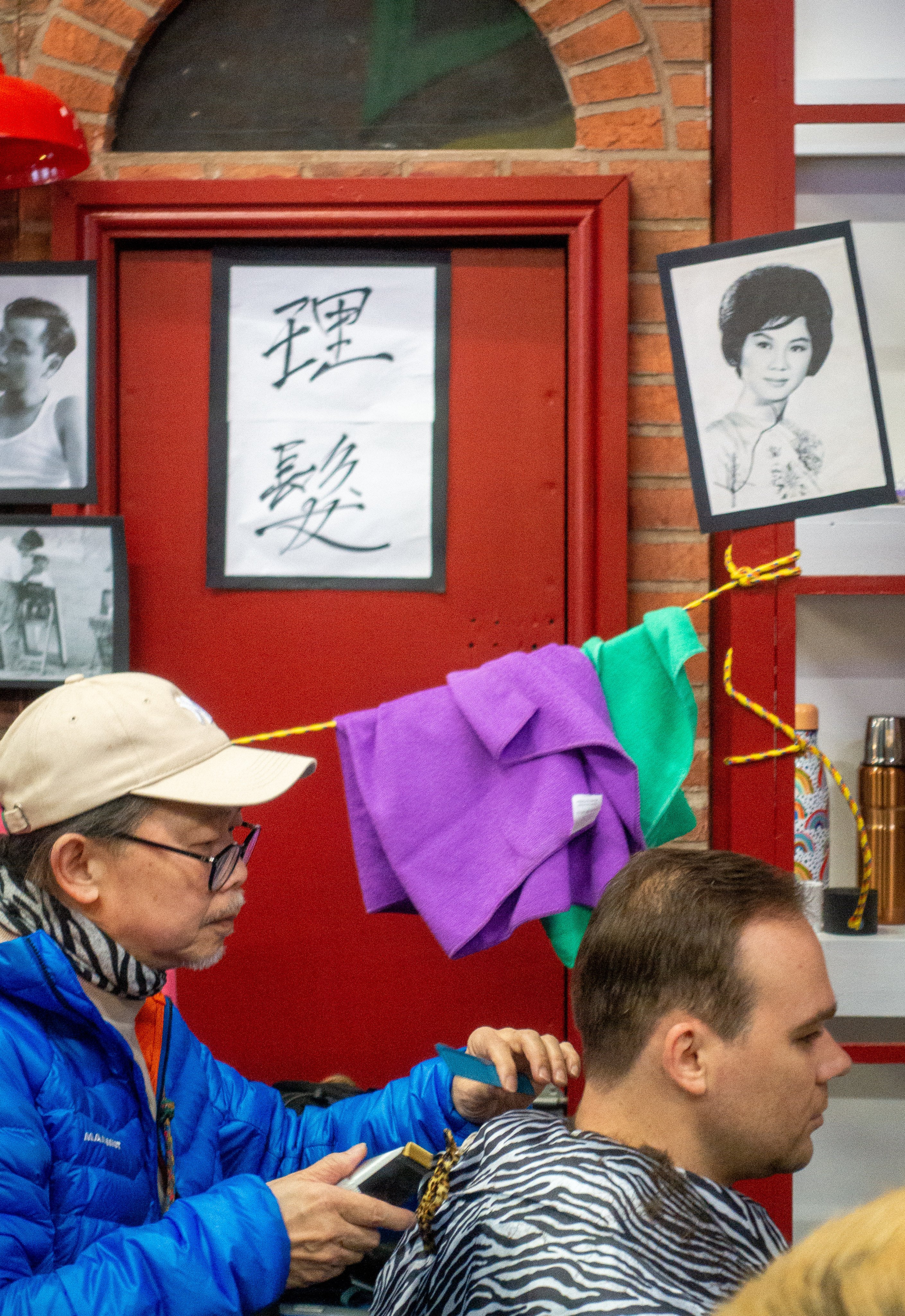 A barber cuts a custormer’s hair at the Hong Kong Market in Glasgow. Photo: Sarah Gillespie