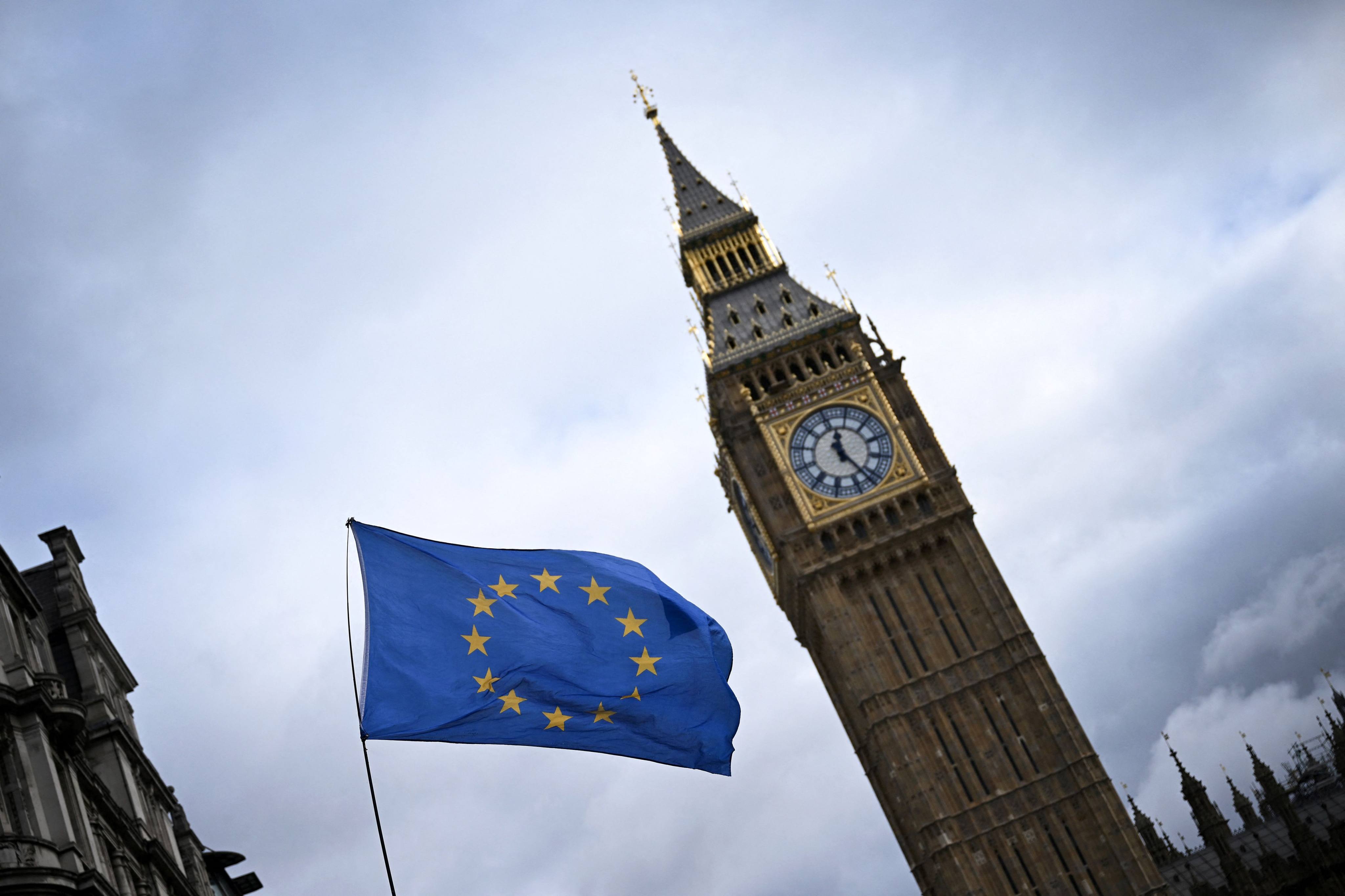 A European Union flag, flown by anti-Brexit activists, flaps in wind, in front of the Elizabeth Tower, commonly known as Big Ben, in central London on March 1. Britain agreed on Friday to join the Comprehensive and Progressive Agreement for Trans-Pacific Partnership, its biggest trade deal since leaving the European Union three years ago. Photo: AFP 