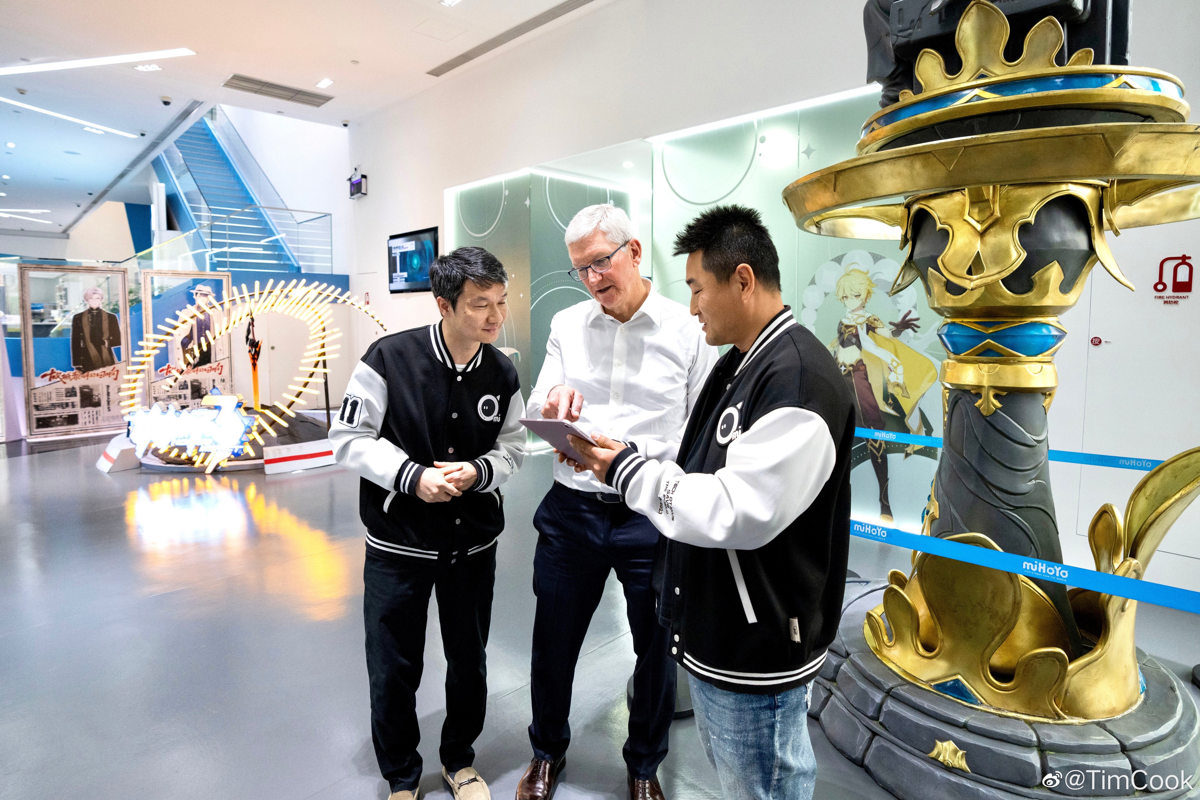 Apple chief executive Tim Cook, centre, meets miHoYo co-founder Liu Wei, left, and an unidentified developer of hit game Genshin Impact, at the Chinese video gaming company’s headquarters in Shanghai on March 30, 2023. Photo: Weibo 