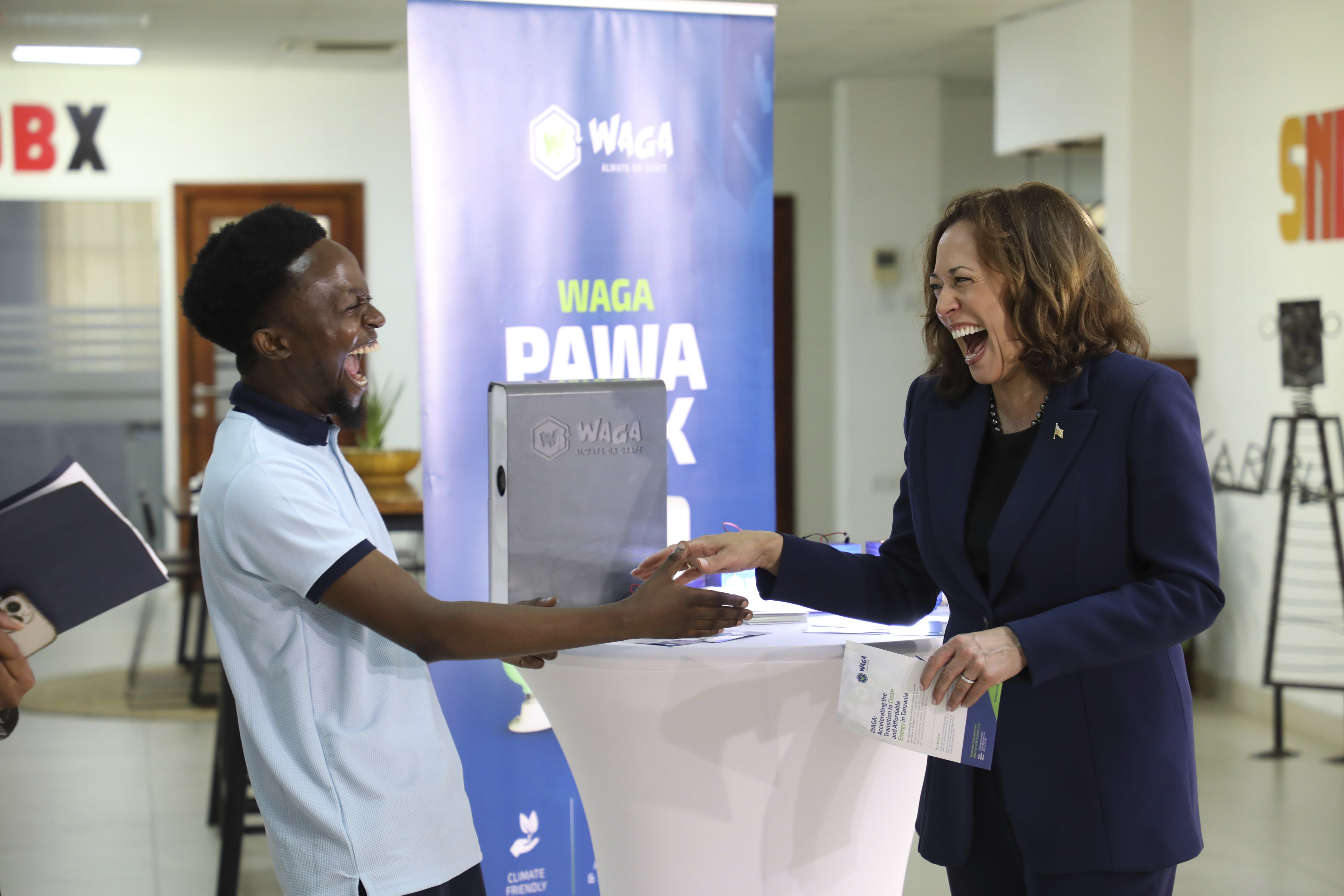 US Vice-President Kamala Harris shares a light moment with a Tanzanian climate entrepreneur in Dar es Salaam on Thursday. Photo: AP