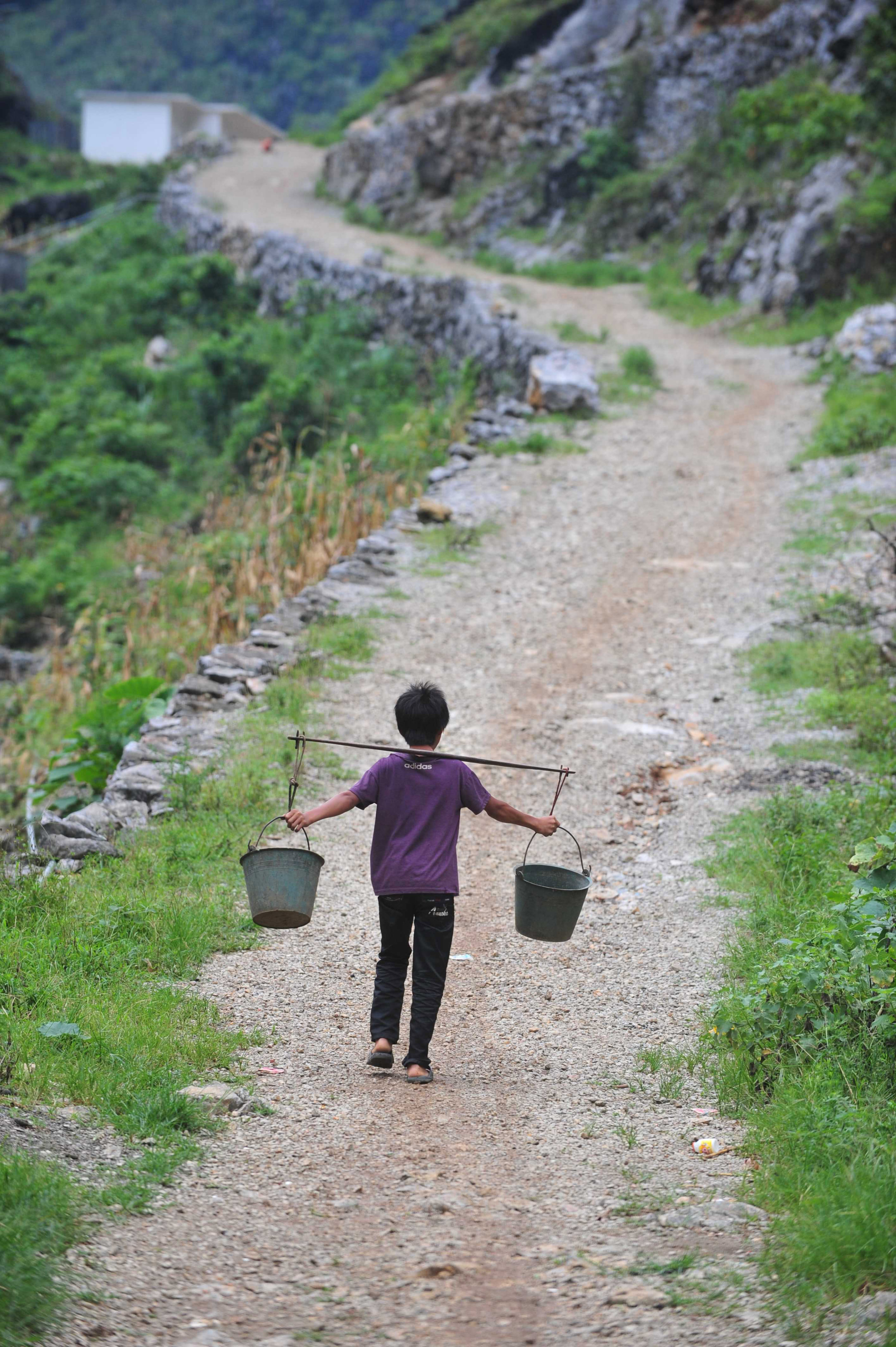 A villager goes uphill to get water in Nongyong village, southern China’s Guangxi Zhuang Autonomous Region. Photo: Xinhua