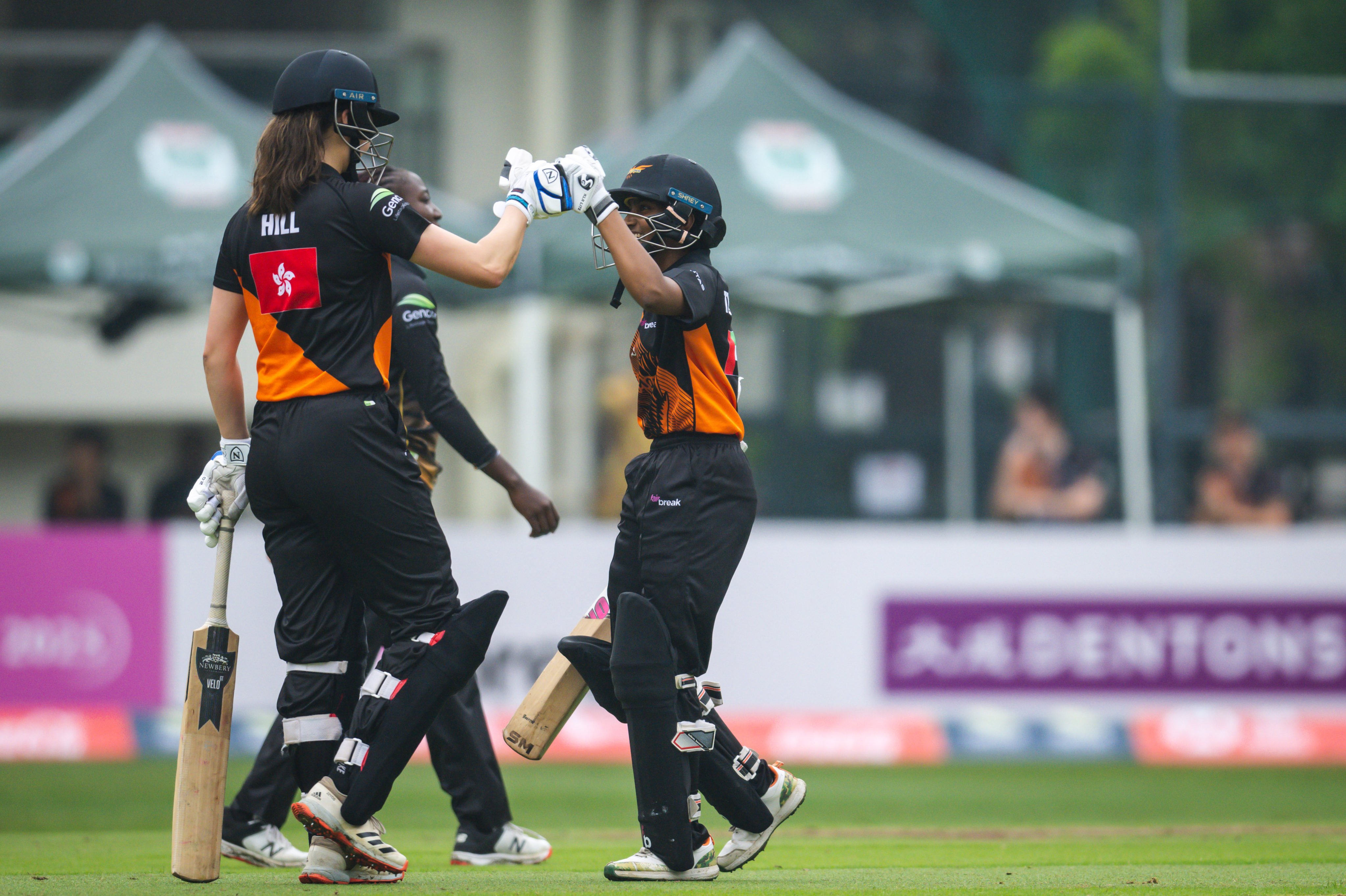 Hong Kong’s Mariko Hill (left) and Falcons teammate Theertha Satish bump fists during their game against Tornadoes at Kowloon Cricket Club in the 2023 FairBreak Invitational. Photo: FairBreak Invitational