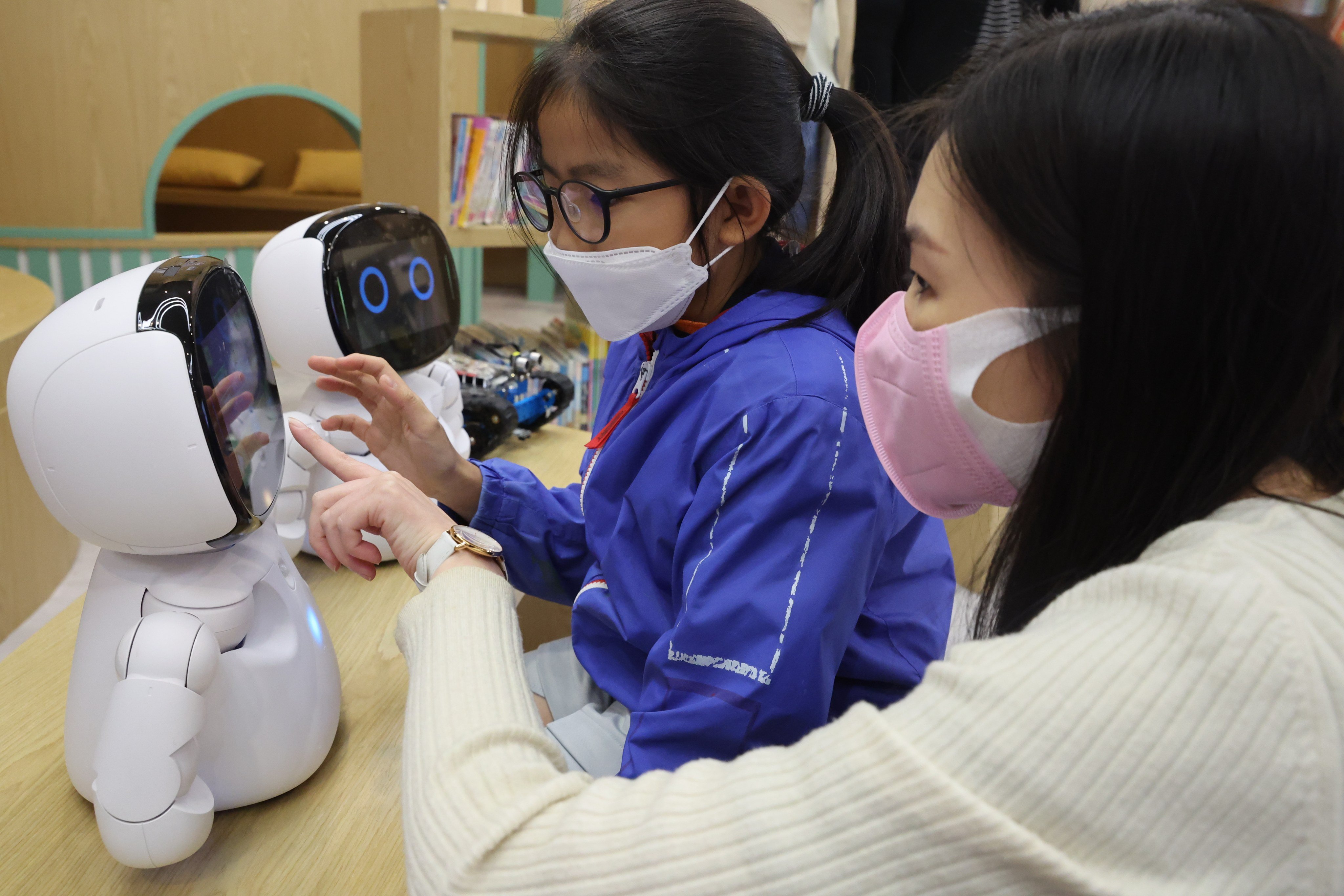 A teacher and student play with a robot at Asbury Methodist Primary School in Kwai Chung on November 4, 2022. The heavy focus on STEM education in Hong Kong has come at the expense of liberal arts education. Photo: Edmond So