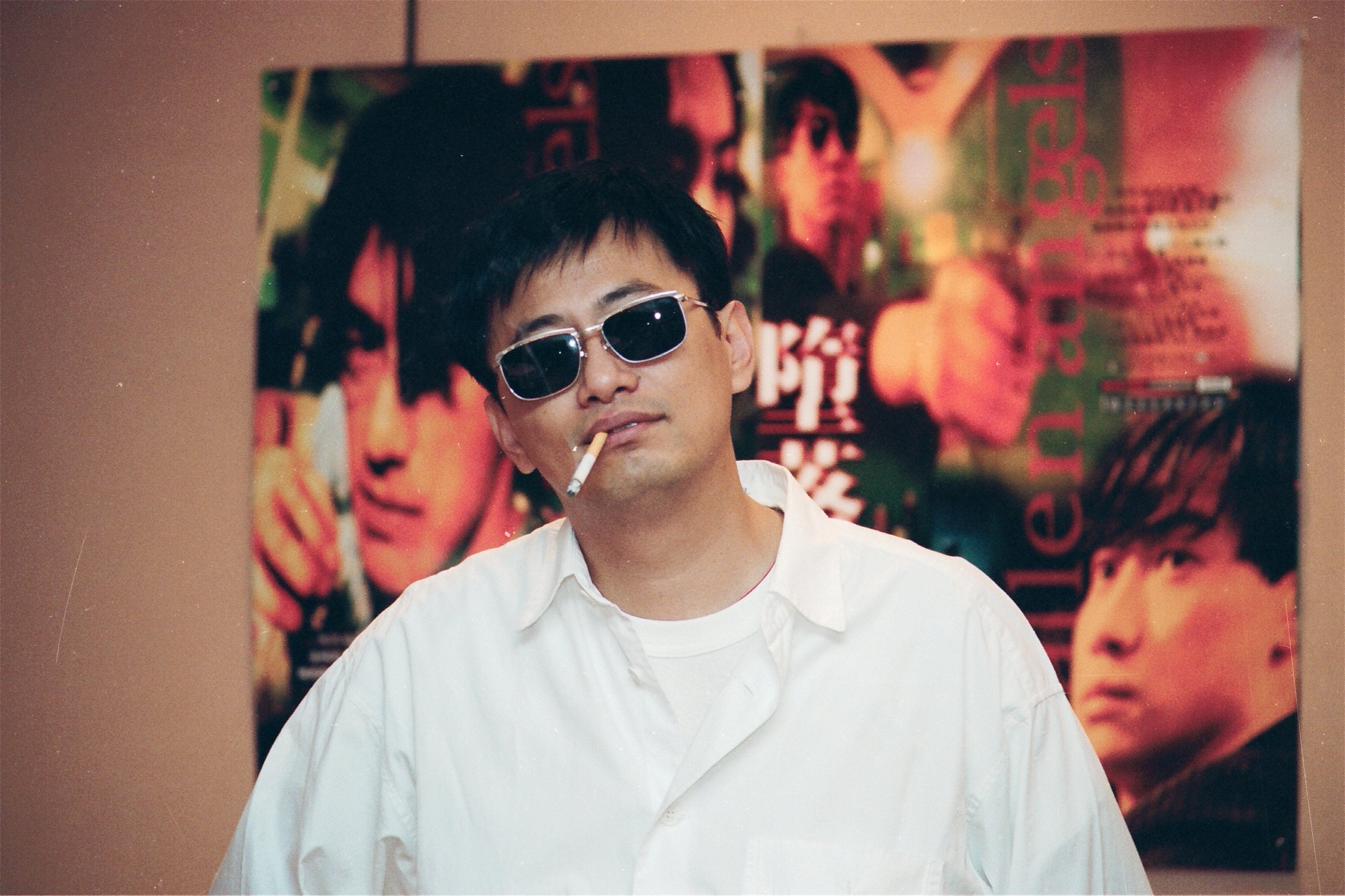 Wong Kar-wai, pictured in front of a poster advertising his movie Fallen Angels, in 1995. Photo: SCMP