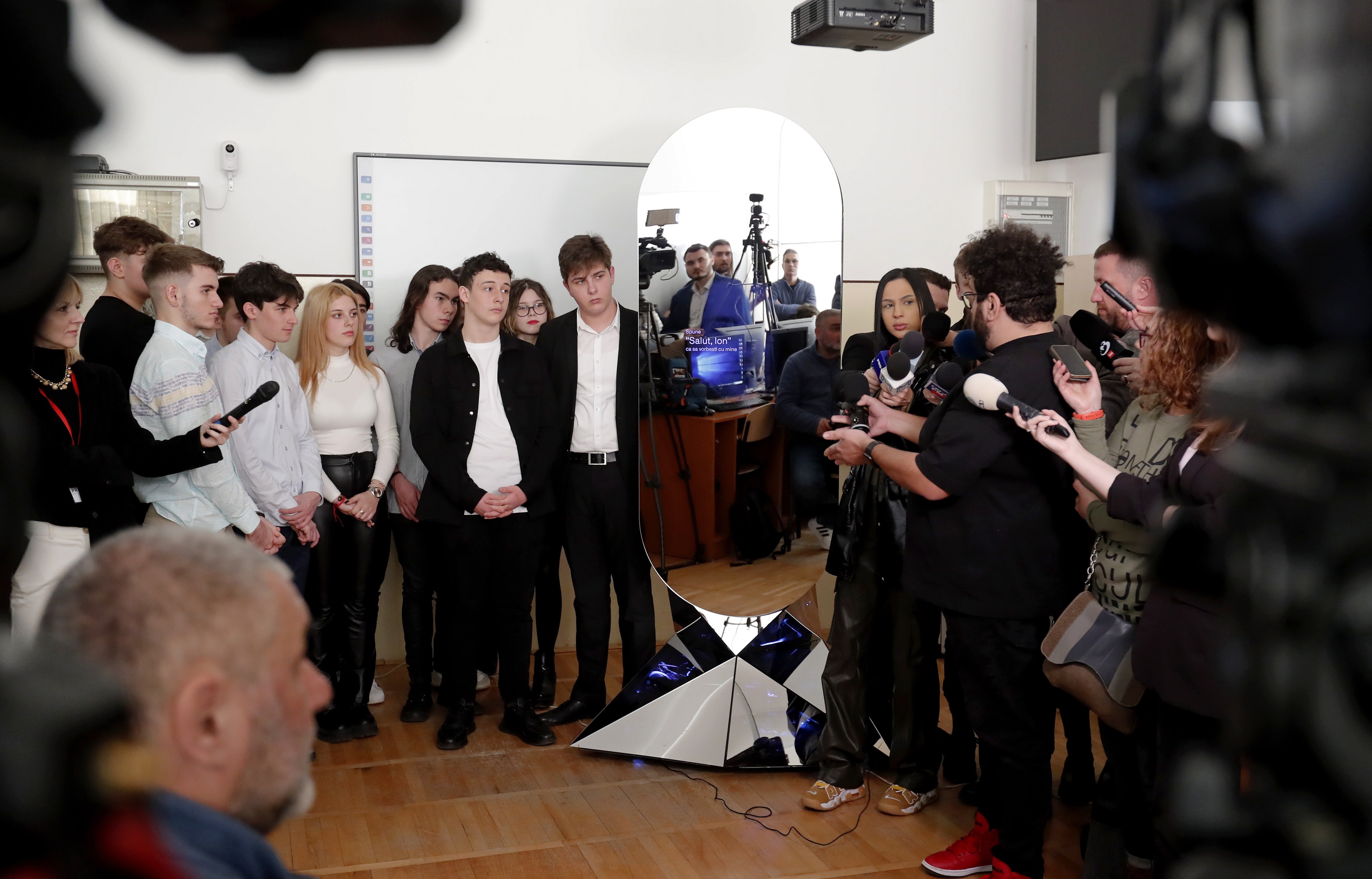 AI robot “ION” interacts with the students of Aurel Vlaicu National College in Bucharest, Romania, on March 13. ION is an honorary government adviser, created by the AI and research community and universities in Romania to collect and represent the wishes, thoughts and problems of Romanians to the government. Photo: EPA-EFE