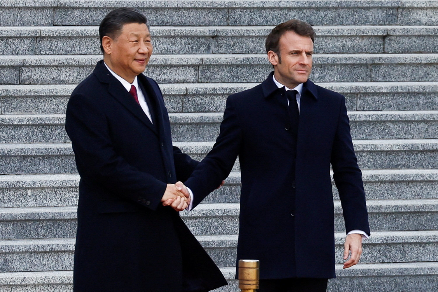 Chinese President Xi Jinping shakes hands with French President Emmanuel Macron at the Great Hall of the People, in Beijing, on Thursday. Photo: Reuters