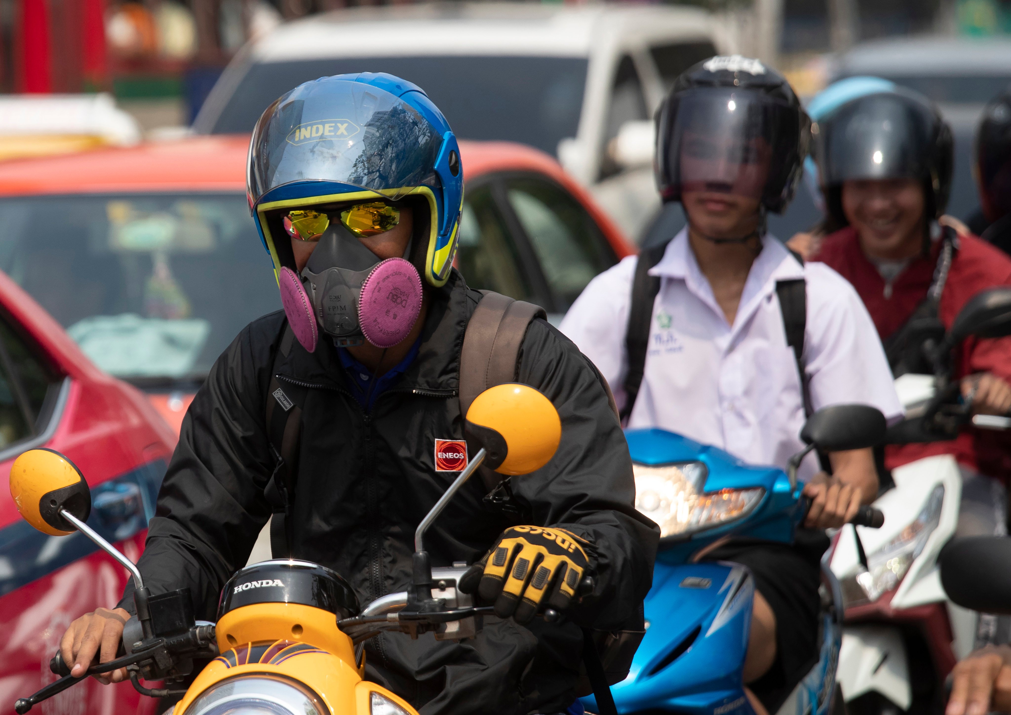 Motorcyclists wear face masks to protect from the poor air quality in Bangkok. Photo: AP