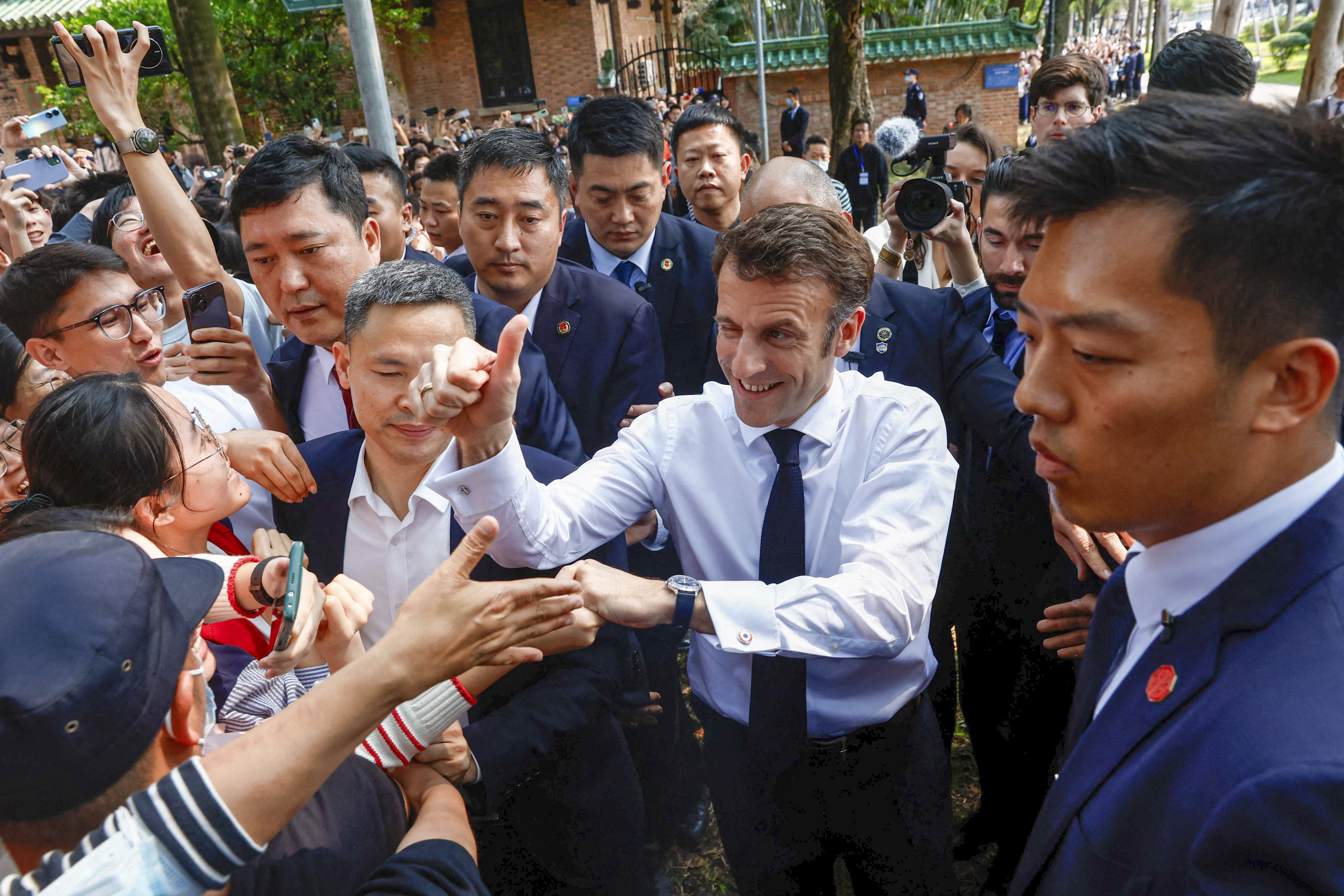 French President Emmanuel Macron is greeted by students as he arrives at Sun Yat-sen University in Guangzhou on Friday. Photo: AFP
