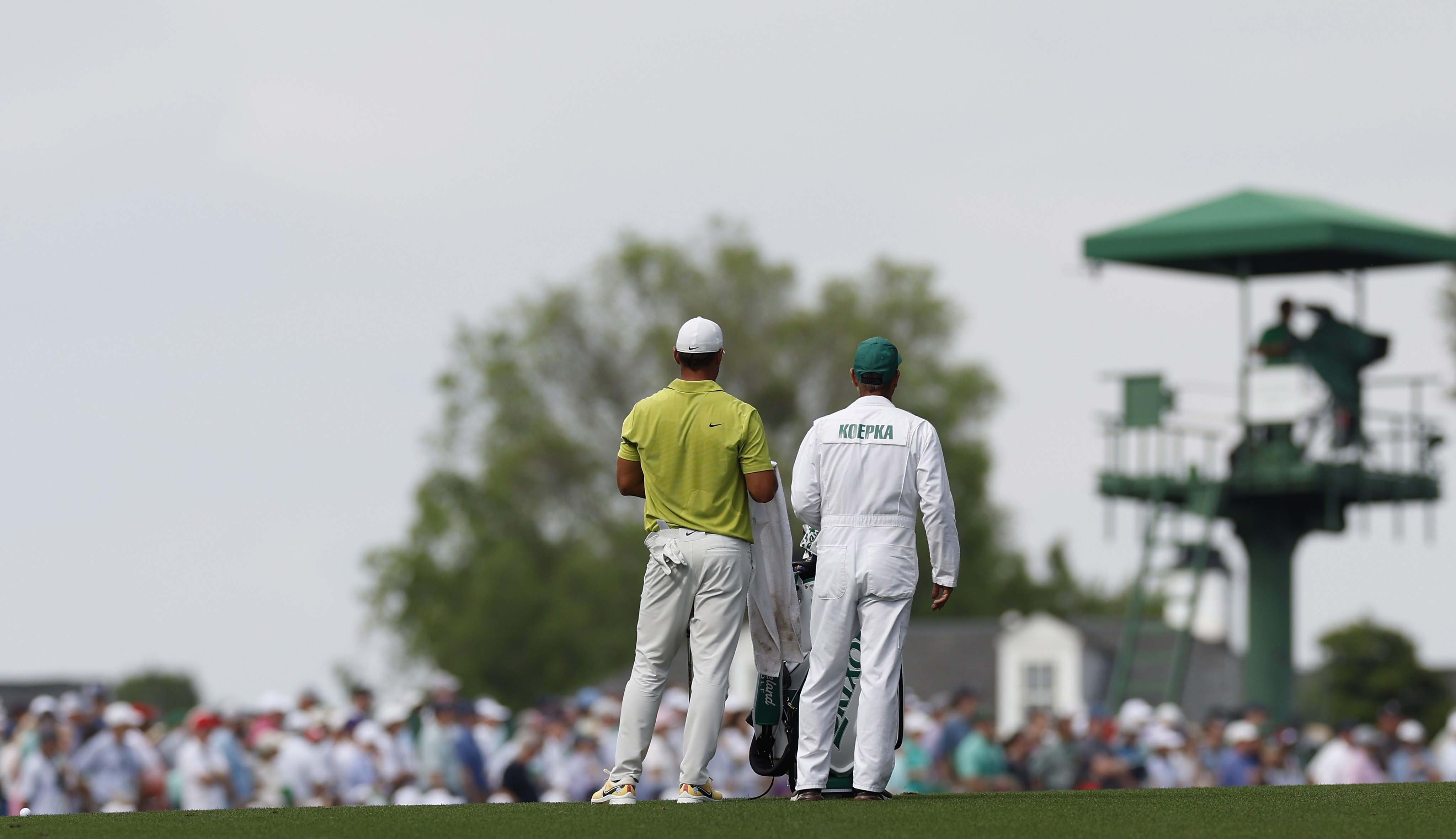 Brooks Koepka (left) and caddie Ricky Elliott stand on the 18th fairway during the first round of the Masters.  Photo: EPA-EFE