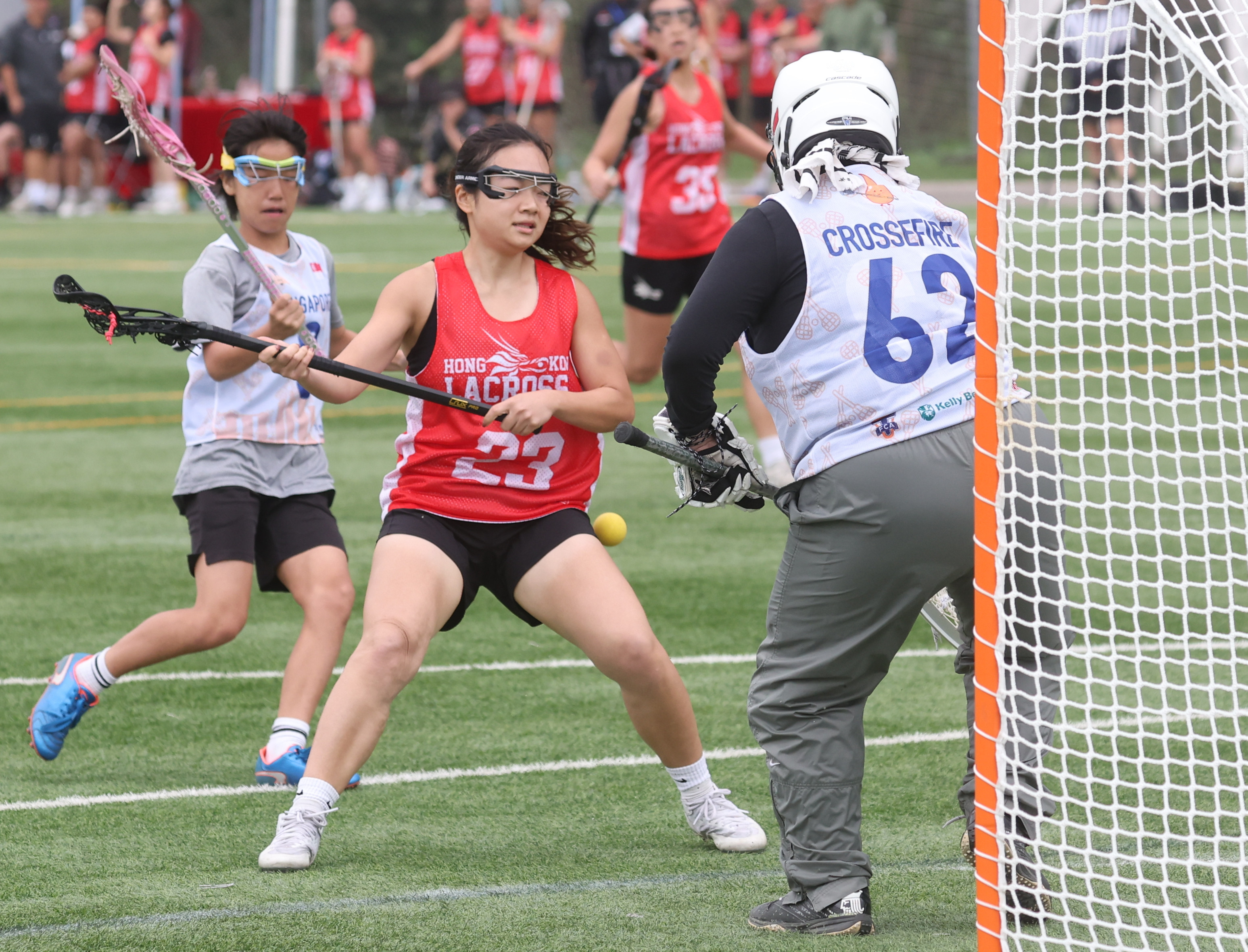 Hong Kong player Claudia Chie Tsze-tung (centre) in action against Singapore club Crossfire during the second day of the 2023 Hong Kong Lacrosse Open, Photo: Yik Yeung-man