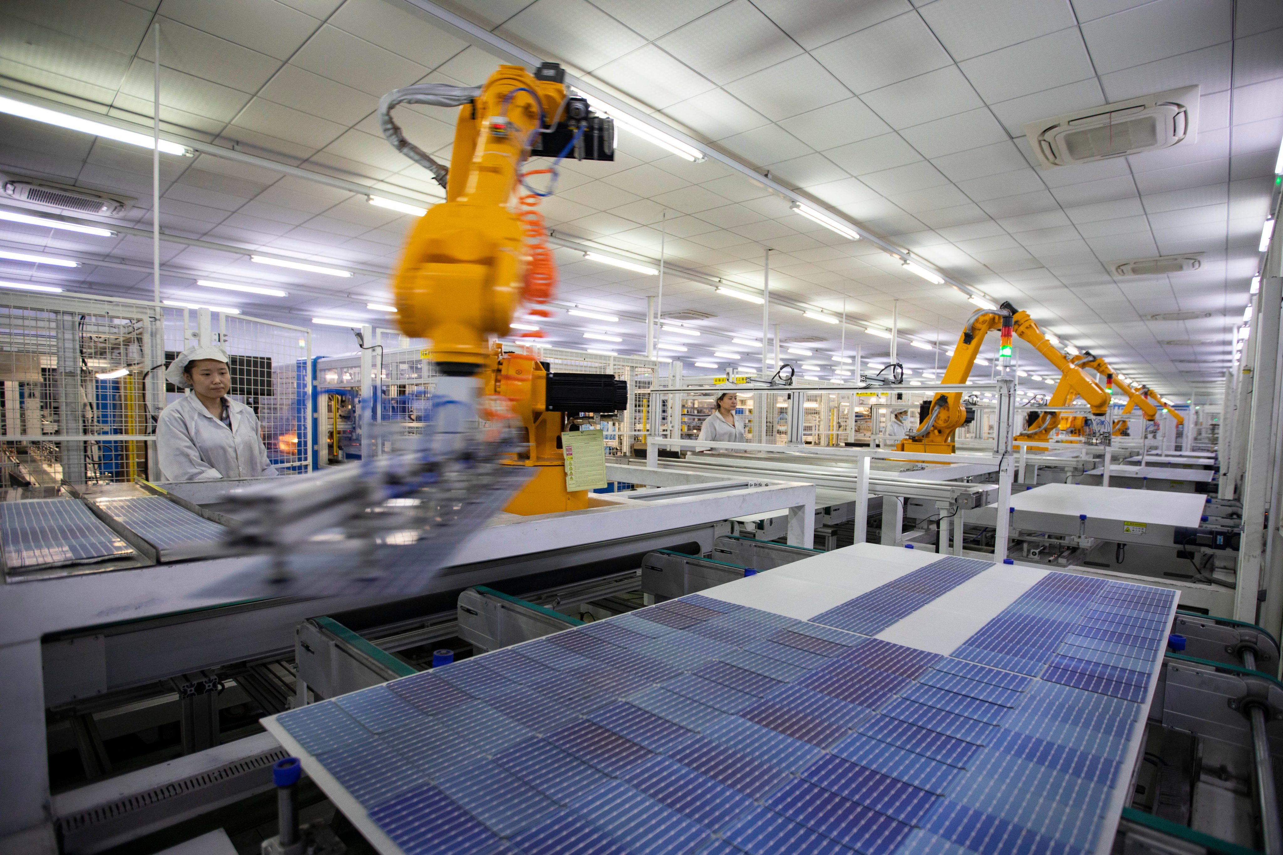 Employees work at a company producing solar modules in Dongying, east China’s Shandong province. Photo: Xinhua