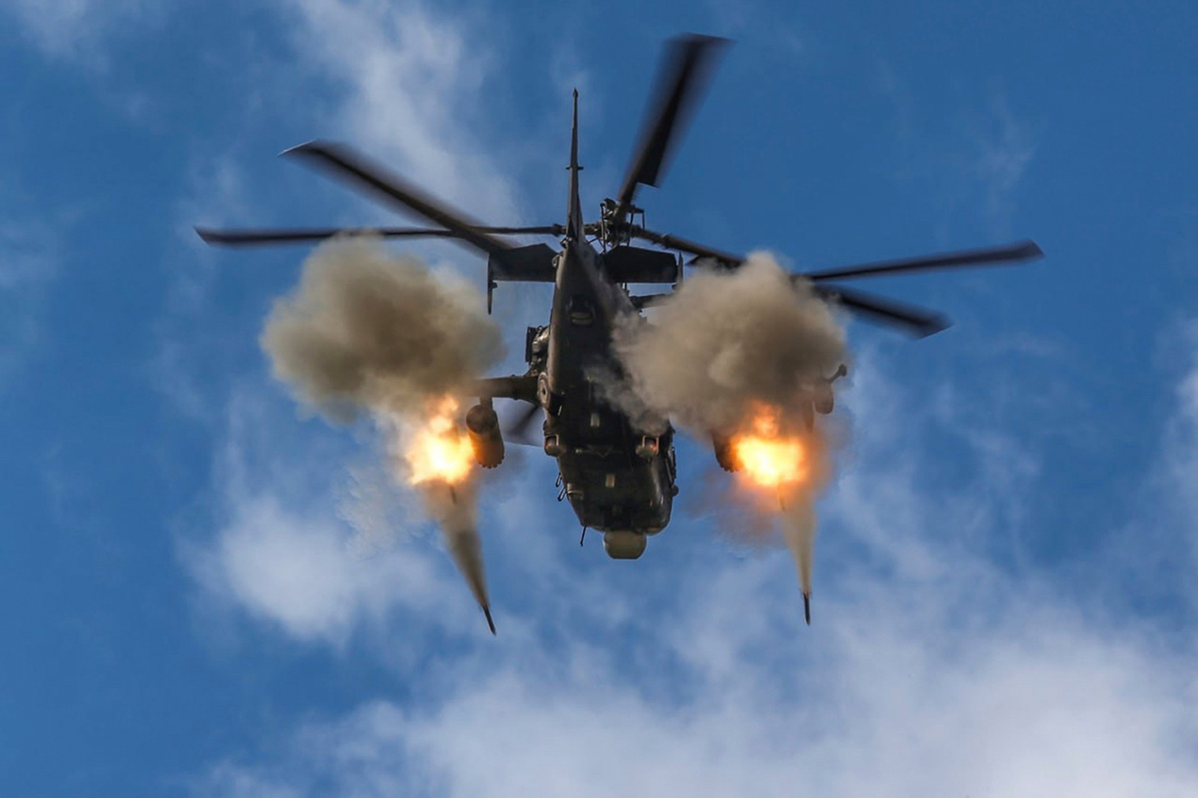 A helicopter gunship is seen firing rockets. Witnesses said a Myanmar military helicopter fired at the site in Kanbalu township after a jet had dropped bombs on the area. Photo: Russian Defence Ministry Press Service via AP