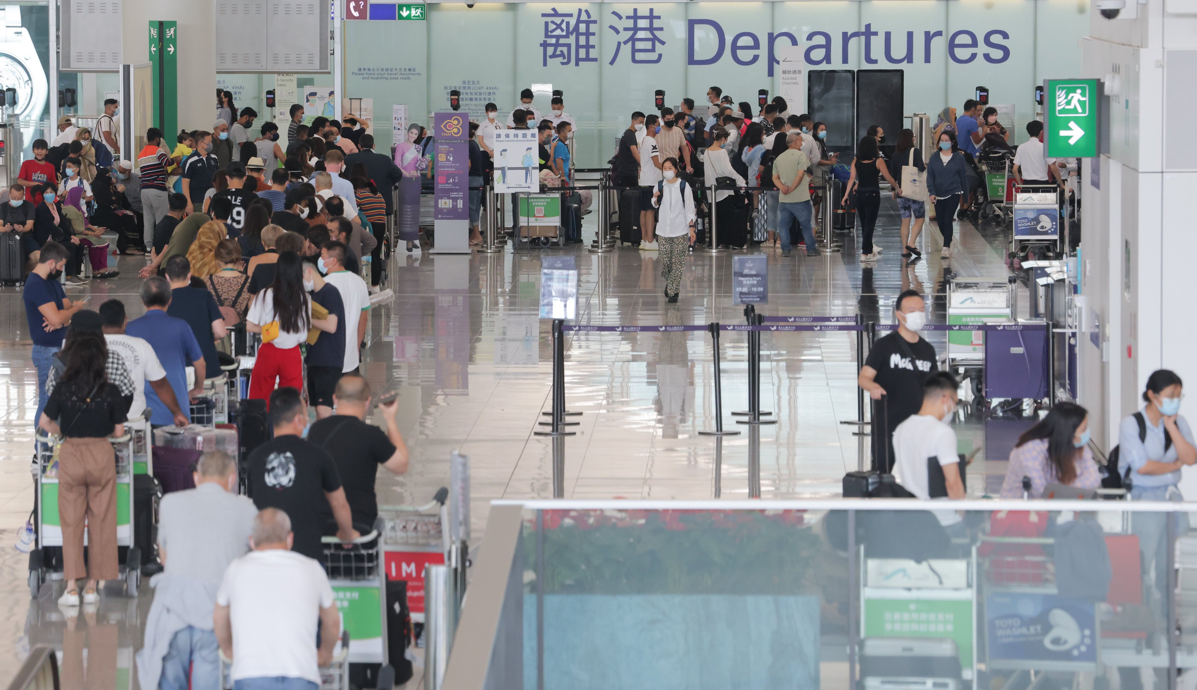 Passengers queue in the departures hall at Hong Kong International Airport on September 21, 2022. The city’s challenge in the face of its latest wave of emigration is to restore a favourable environment at home and give its talented young people a reason to stay. Photo: Jelly Tse