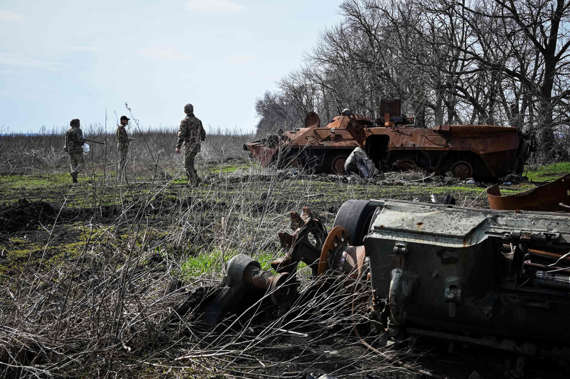 Ukrainian servicemen inspect remains of destroyed armoured vehicles in the north of Kharkiv region on April 11. Photo: AFP