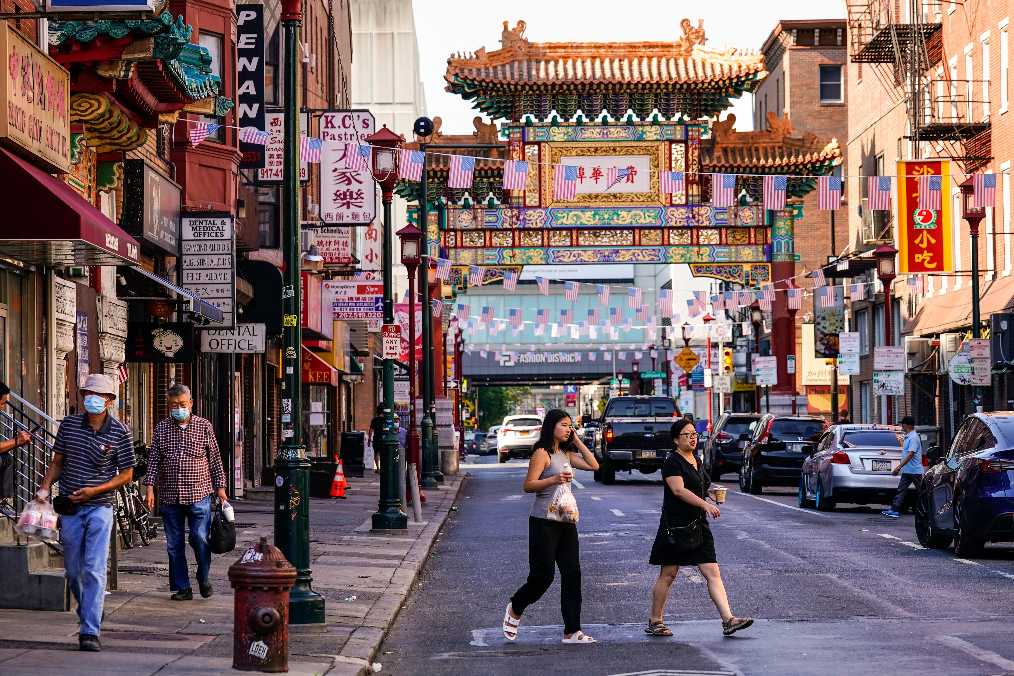 Pedestrians cross 10th Street in the Chinatown neighbourhood of Philadelphia, in July 2022. Photo: AP 