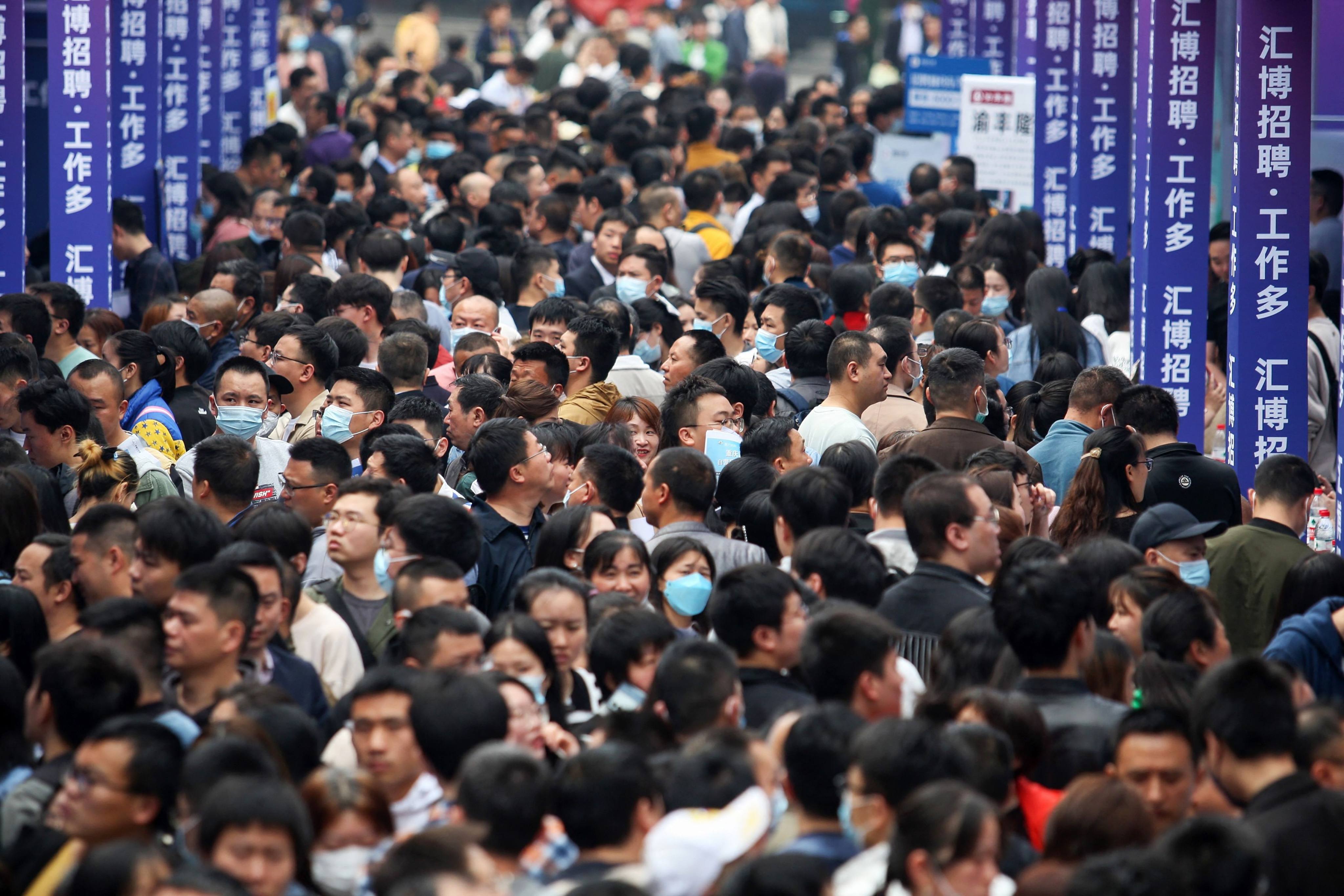 People attend a job fair in Chongqing on April 11. China’s reopening, after abandoning its zero-Covid policy, sets it apart from a world economy facing a significant risk of a hard landing this year. Photo: AFP