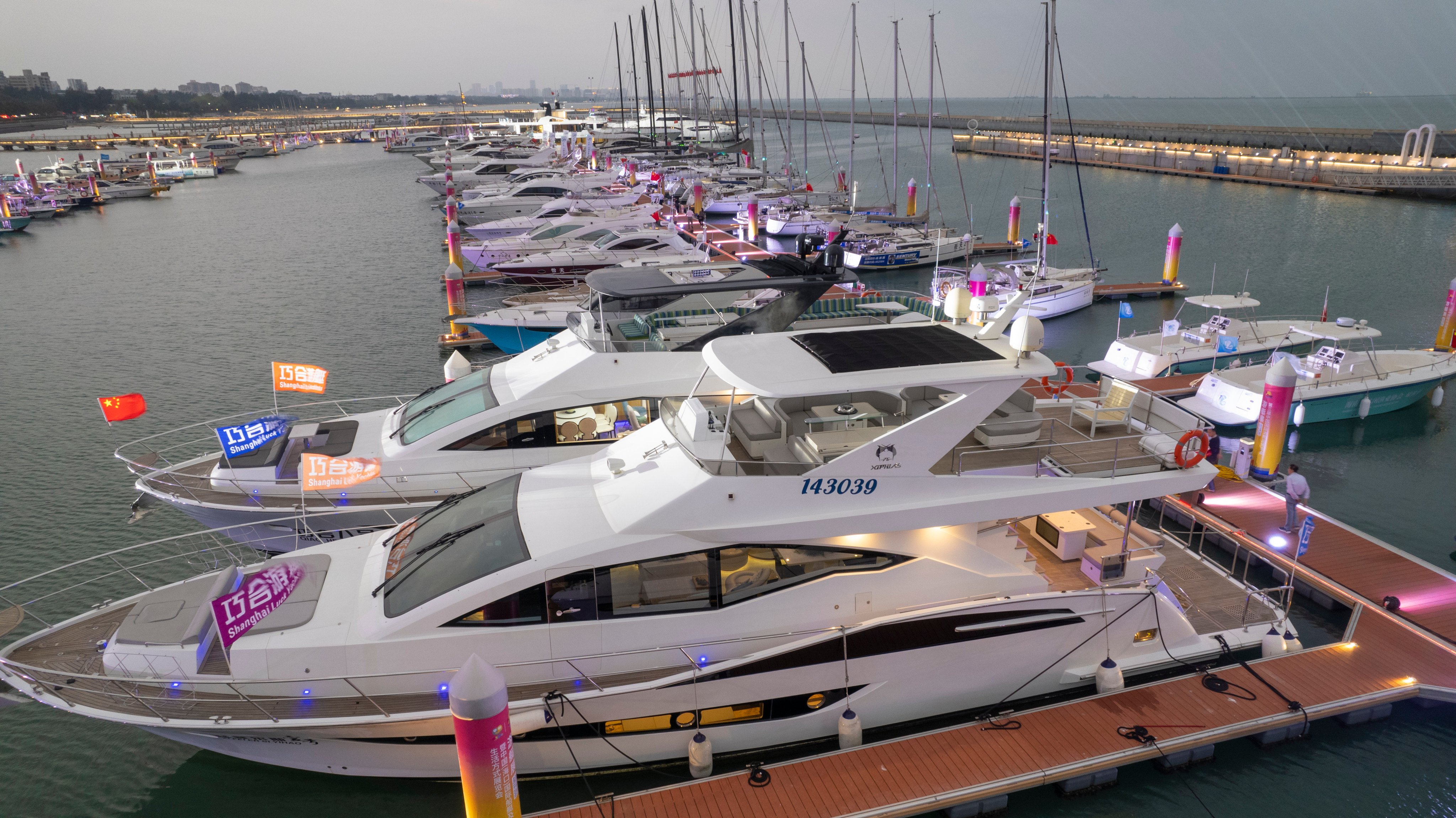 Yachts are moored at the public dock of the Haikou National Sailing Base in Haikou, Hainan province, on Tuesday during the third China International Consumer Products Expo. Photo: Getty Images