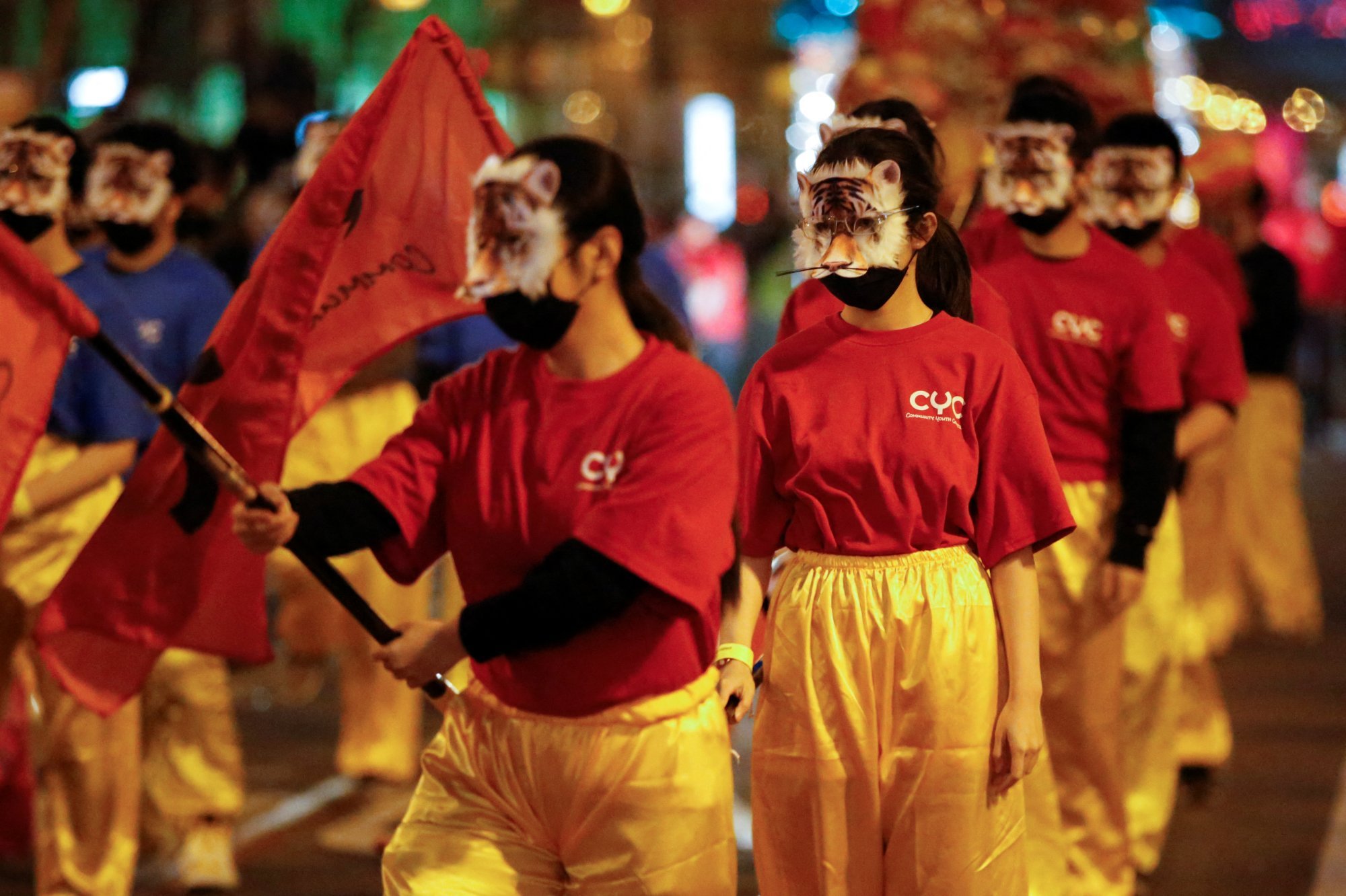 Young performers in tiger masks carry flags down Market Street as part of the annual Lunar New Year parade in San Francisco’s famed Chinatown neighbourhood on February 19, 2022. Photo: Reuters