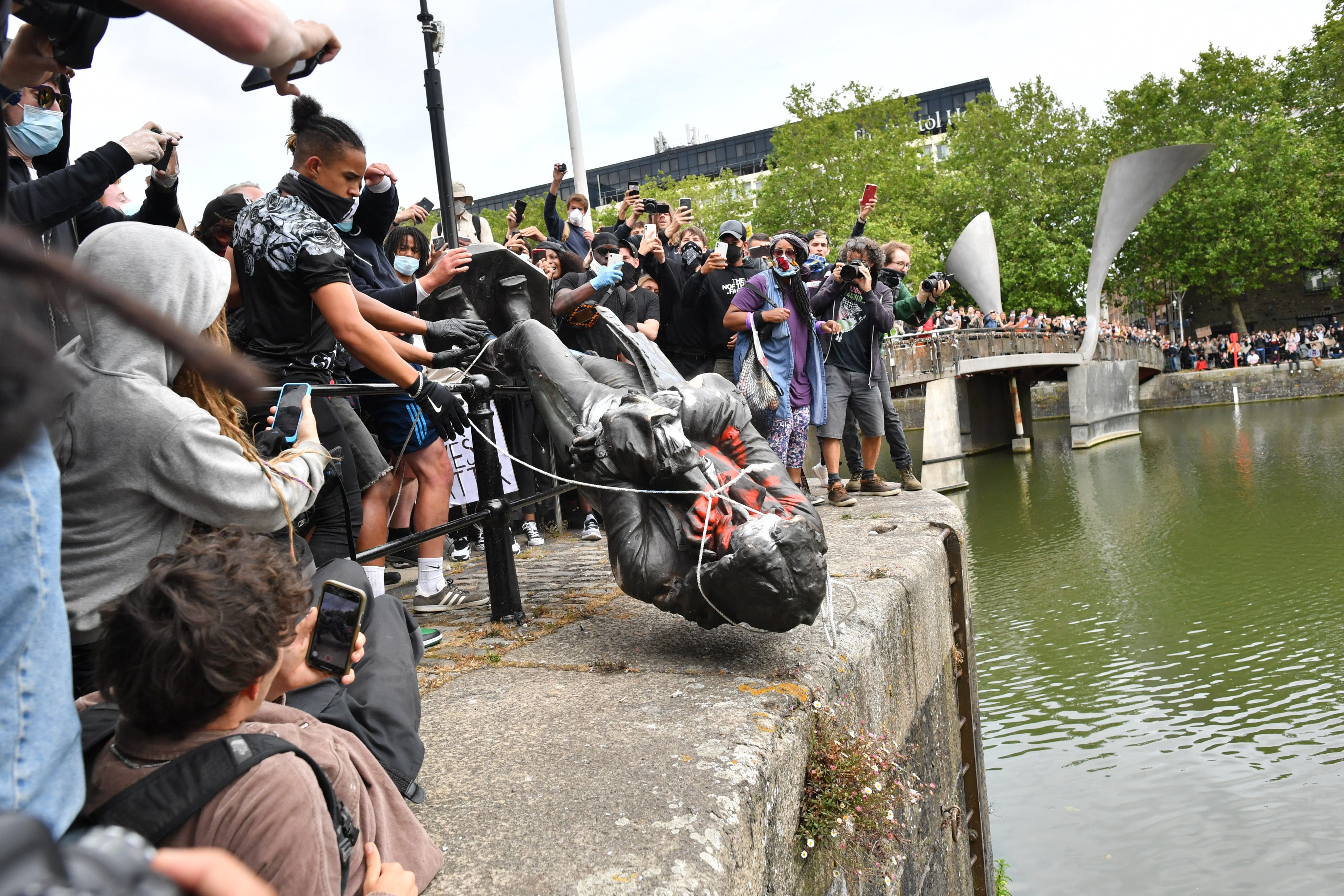 Protesters in England throw a statue of slave trader Edward Colston into Bristol harbour. Might a statue of opium trader H.N. Mody outside the Main Building of the University of Hong Kong suffer a similar fate? Only time will tell. Photo: Getty Images