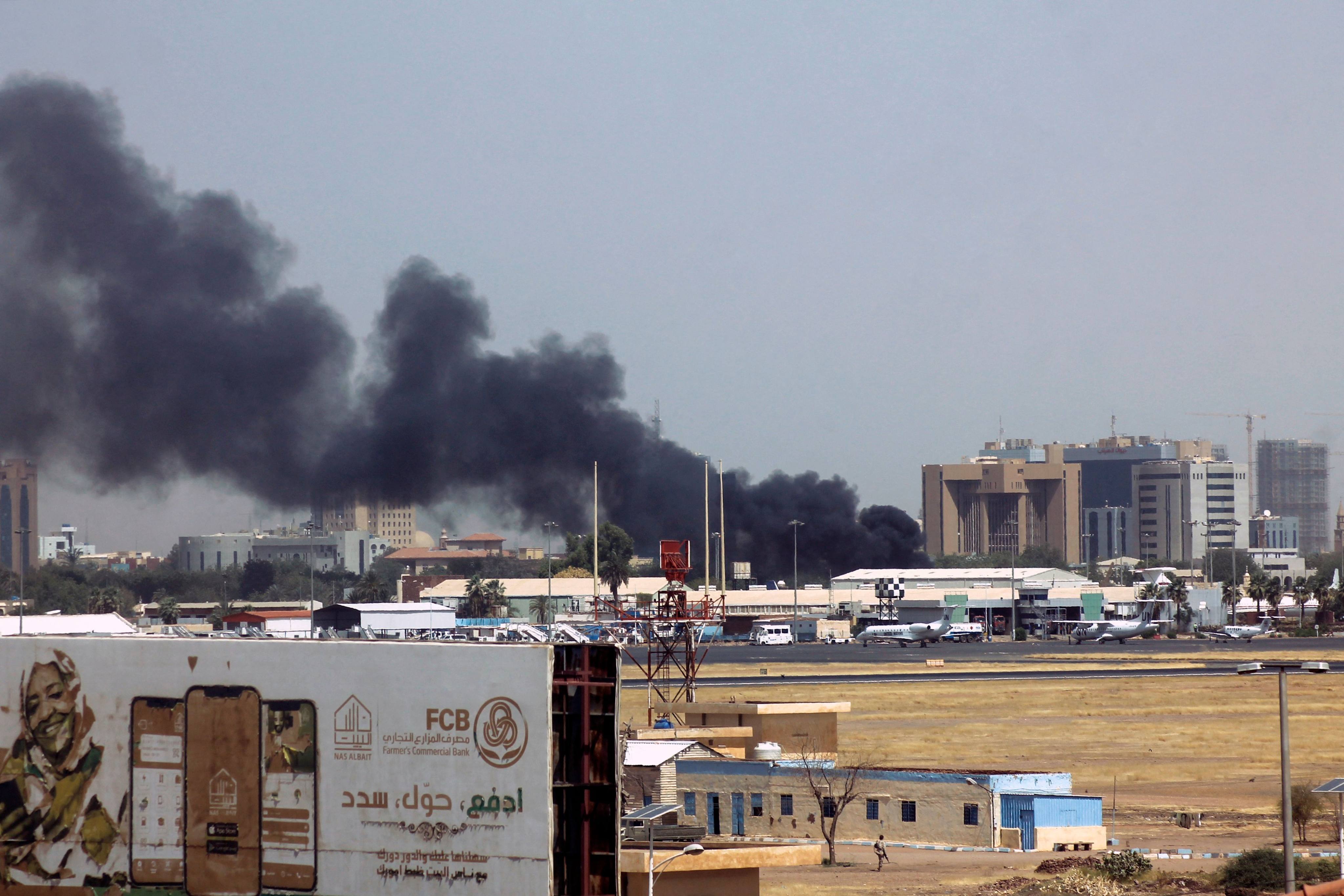 Heavy smoke bellows above buildings in the vicinity of the Khartoum airport on April 15, 2023, amid clashes in the Sudanese capital. Photo: AFP
