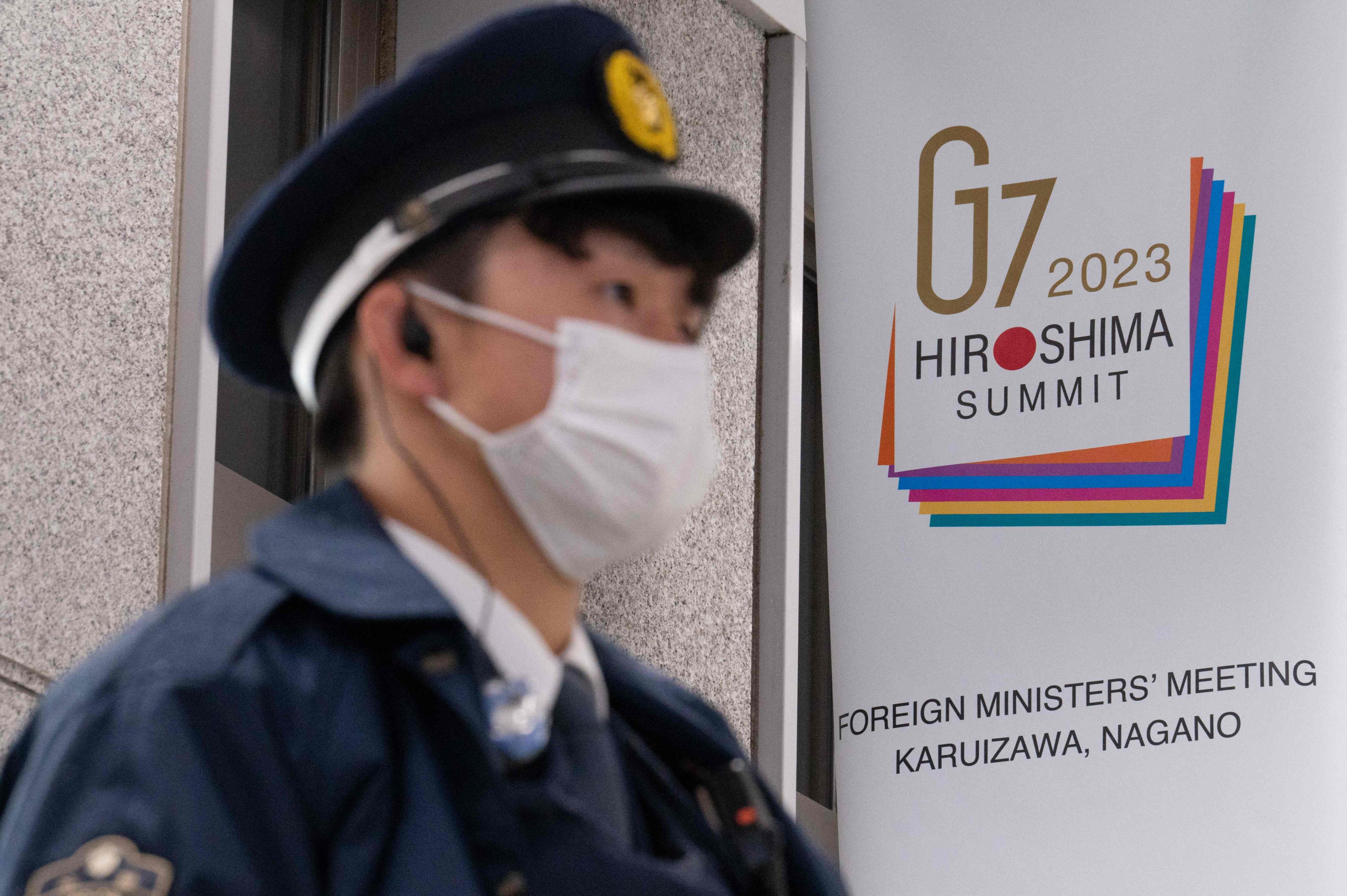 A police officer stands guard next to a G7 banner at Karuizawa station in Karuizawa, Nagano, Japan on Saturday. Photo: AFP