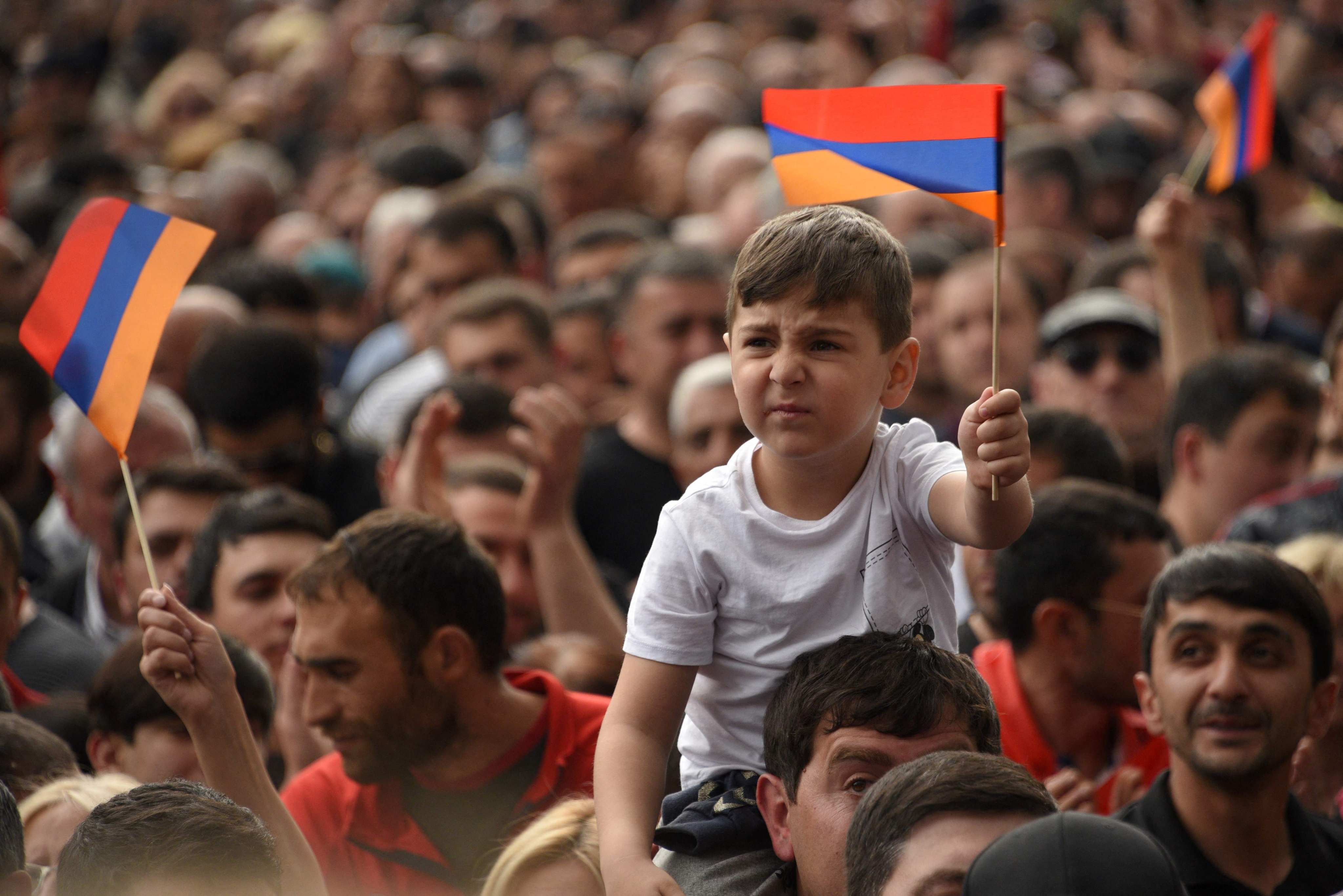 Armenian demonstrators wave national flags during a rally in Yerevan on May 1, 2022, against concessions to arch-foe Azerbaijan over the long-disputed Nagorno-Karabakh region. Photo: AFP