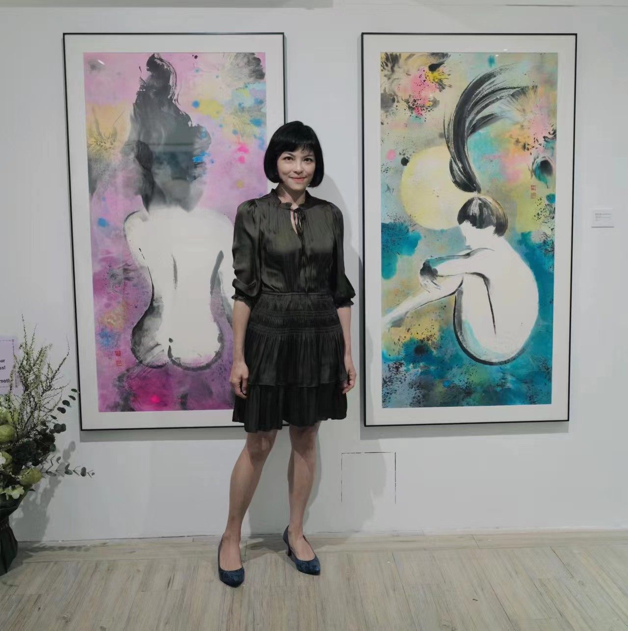 Miranda Yiu with two of her artworks of female nudes, created using the Chinese ink style, at her solo exhibition “Flow color. White”, at Hong Kong’s Yrellag Gallery. Photo: Miranda Yiu