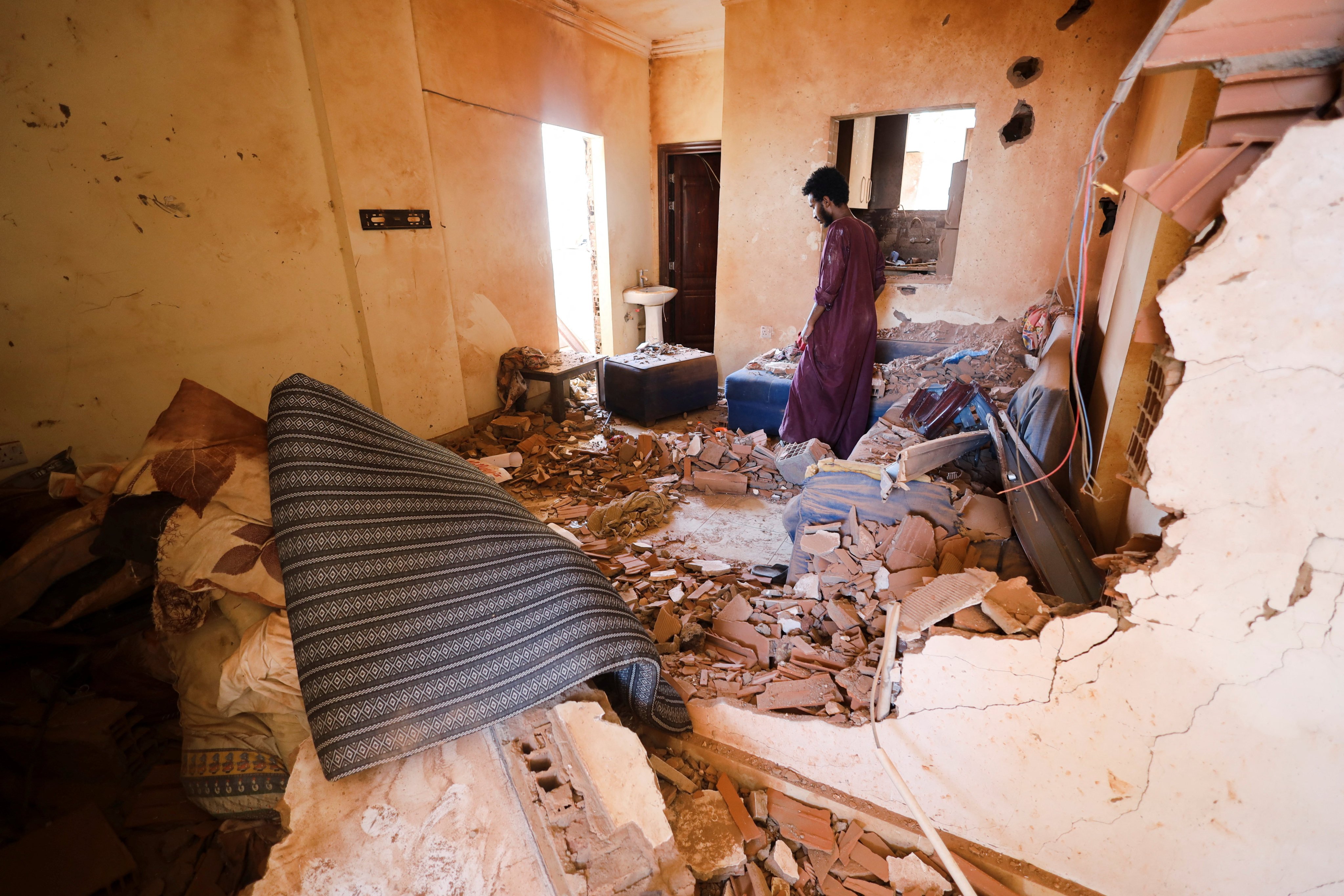 A man surveys the damage inside a Khartoum home damaged during clashes between the Sudan army and the paramilitary Rapid Support Forces. Photo: Reuters