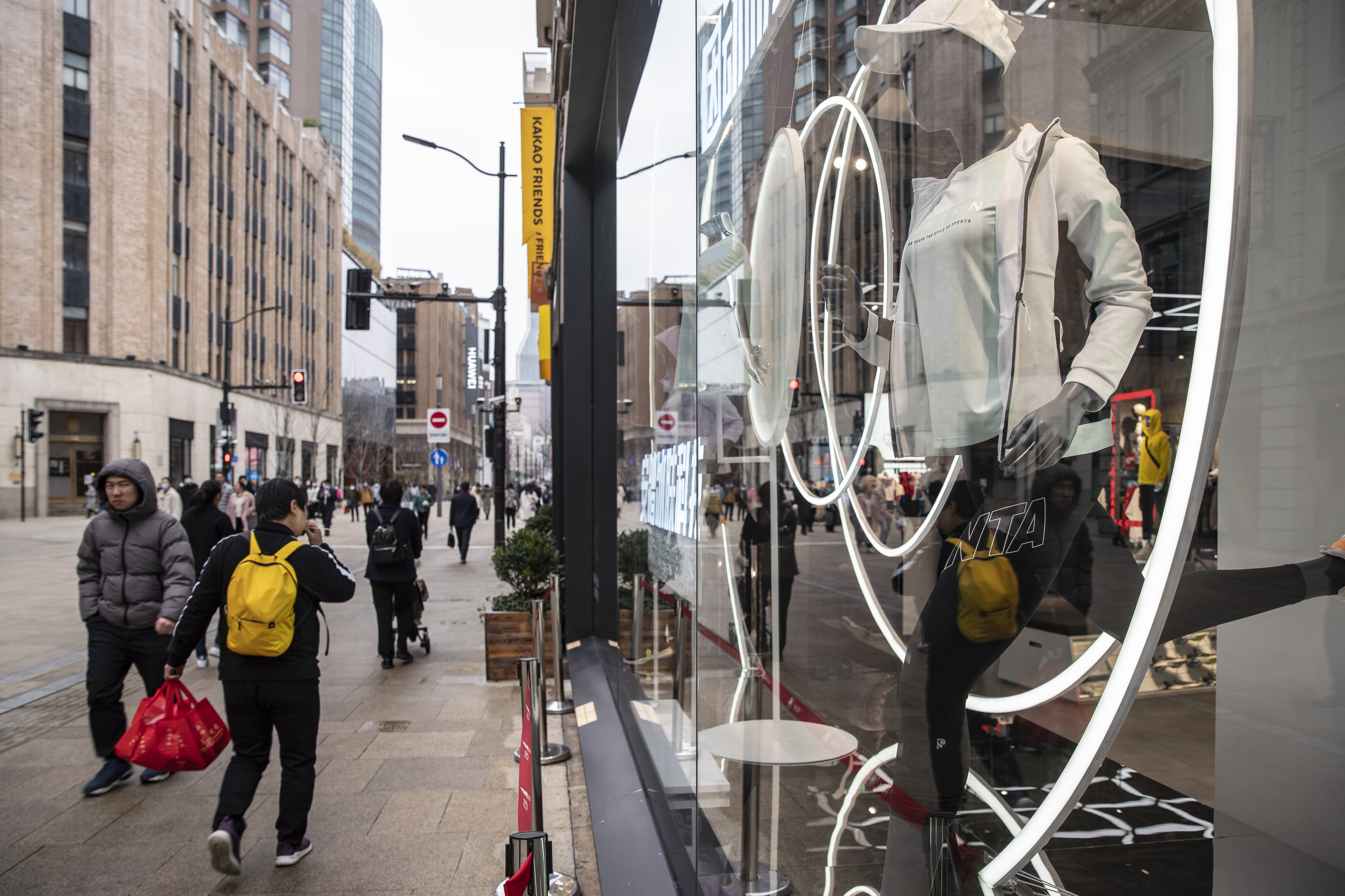 Pedestrians walk past an Anta Sports Products store in Shanghai in March 2021. Photo: bloomberg