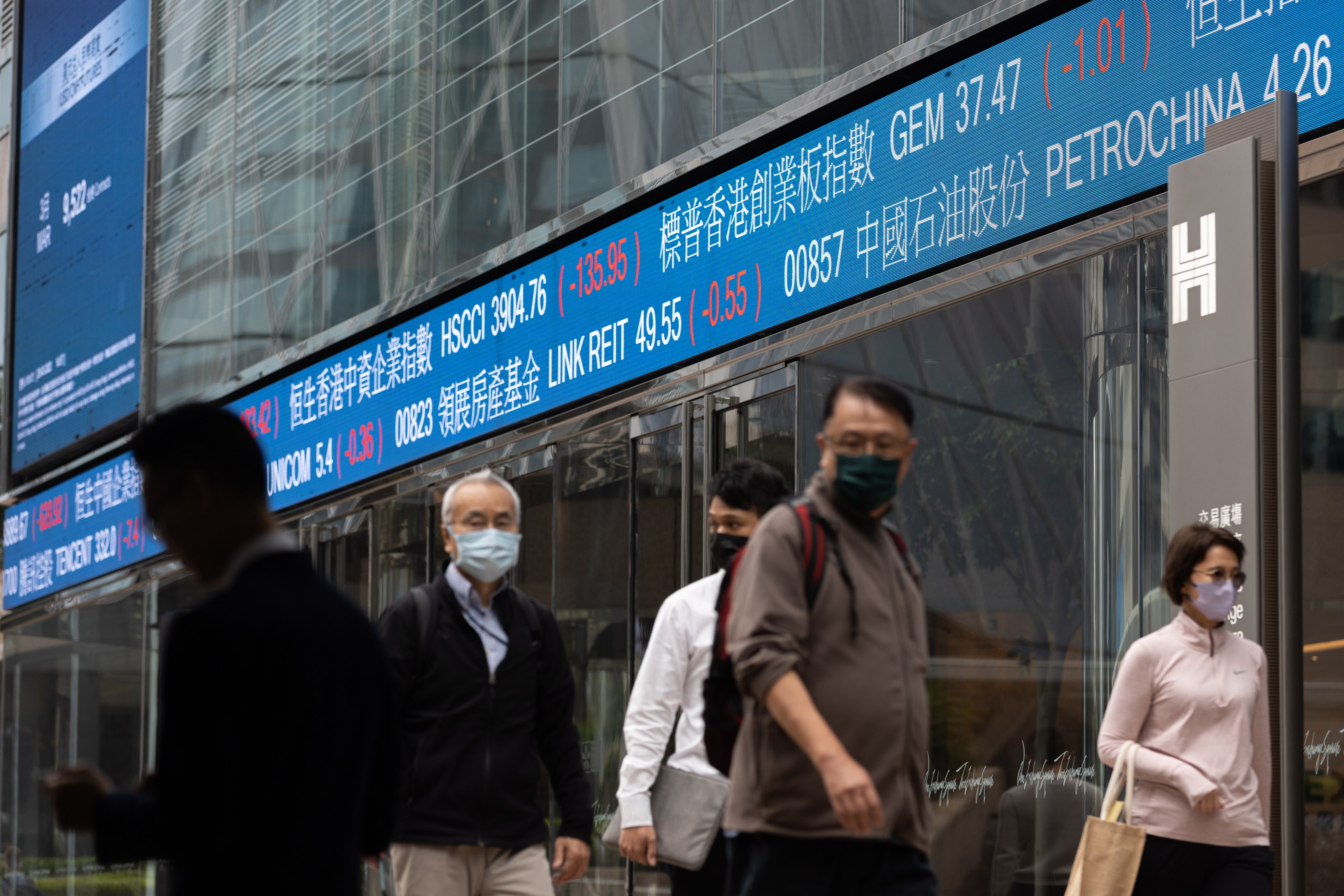 Pedestrians outside Exchange Square, the building housing the Hong Kong stock exchange, March 20, 2023. Photo: EPA-EFE