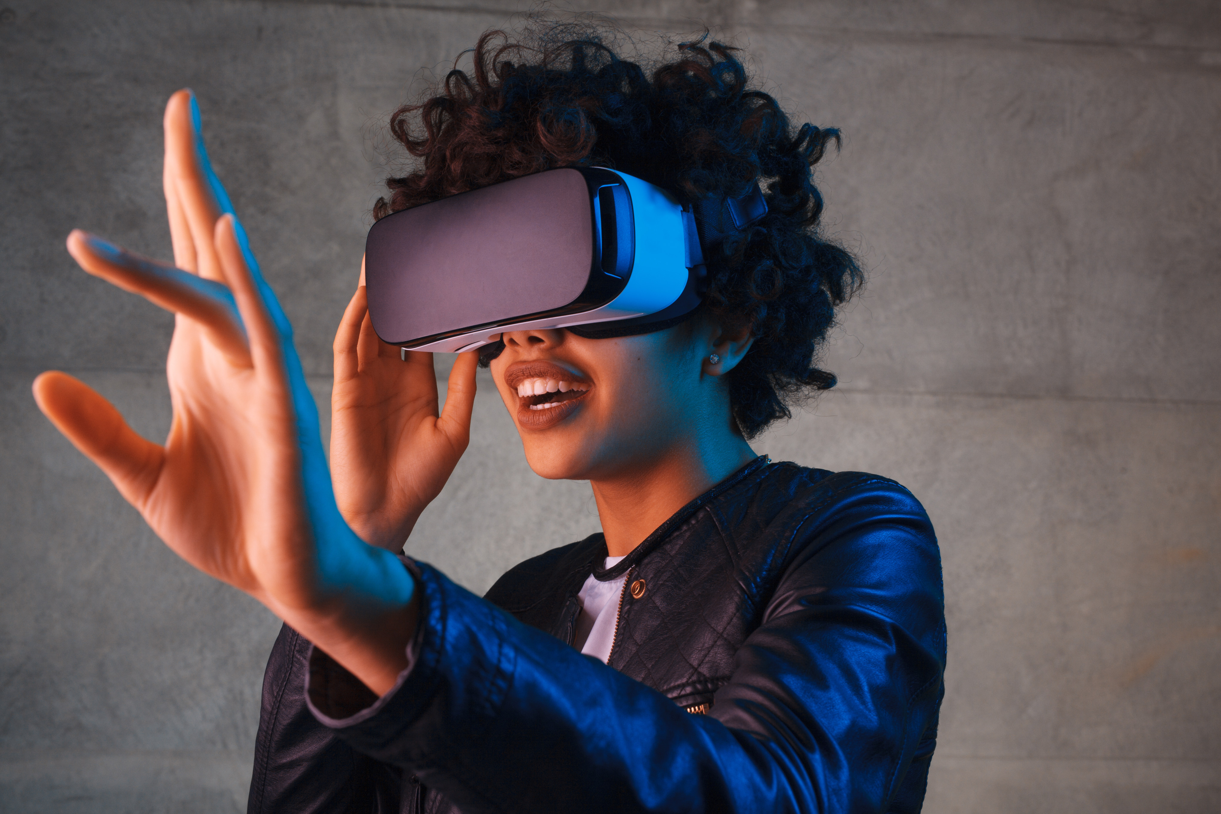 Woman touching the air during the virtual reality experience. Photo: Shutterstock