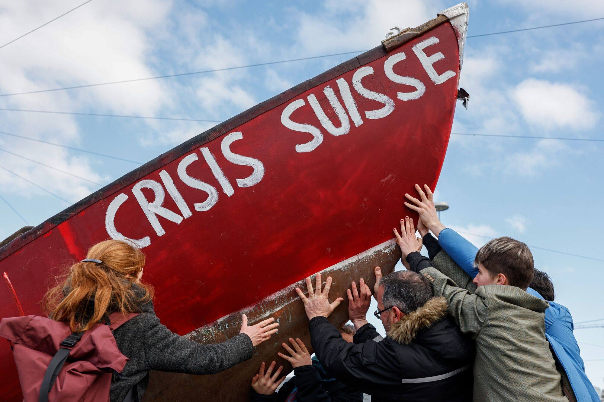 Protestors hold a boat reading ‘Crisis Suisse’ during a demonstration outside the Credit Suisse Group annual general meeting of shareholders in Zurich on April 4. Credit Suisse faced imminent failure if it was not sold to UBS Group in an emergency rescue last month, according to the Swiss central bank. Photo: Bloomberg